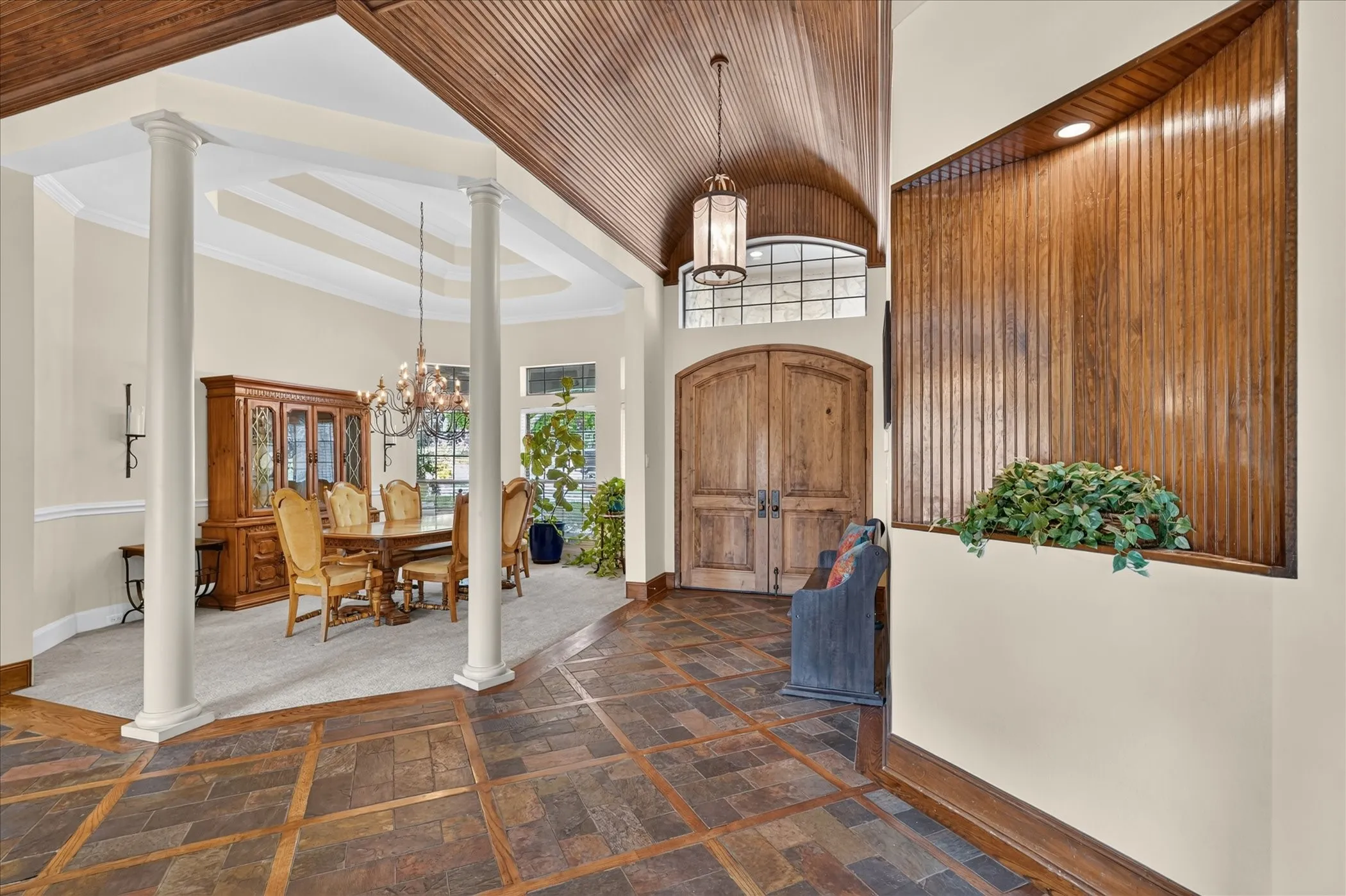 The journey begins as an impressive entry featuring a beadboard barrel ceiling sets a grand, inviting tone, opening to extensive wood flooring, elegant crown molding, and plantation shutters.