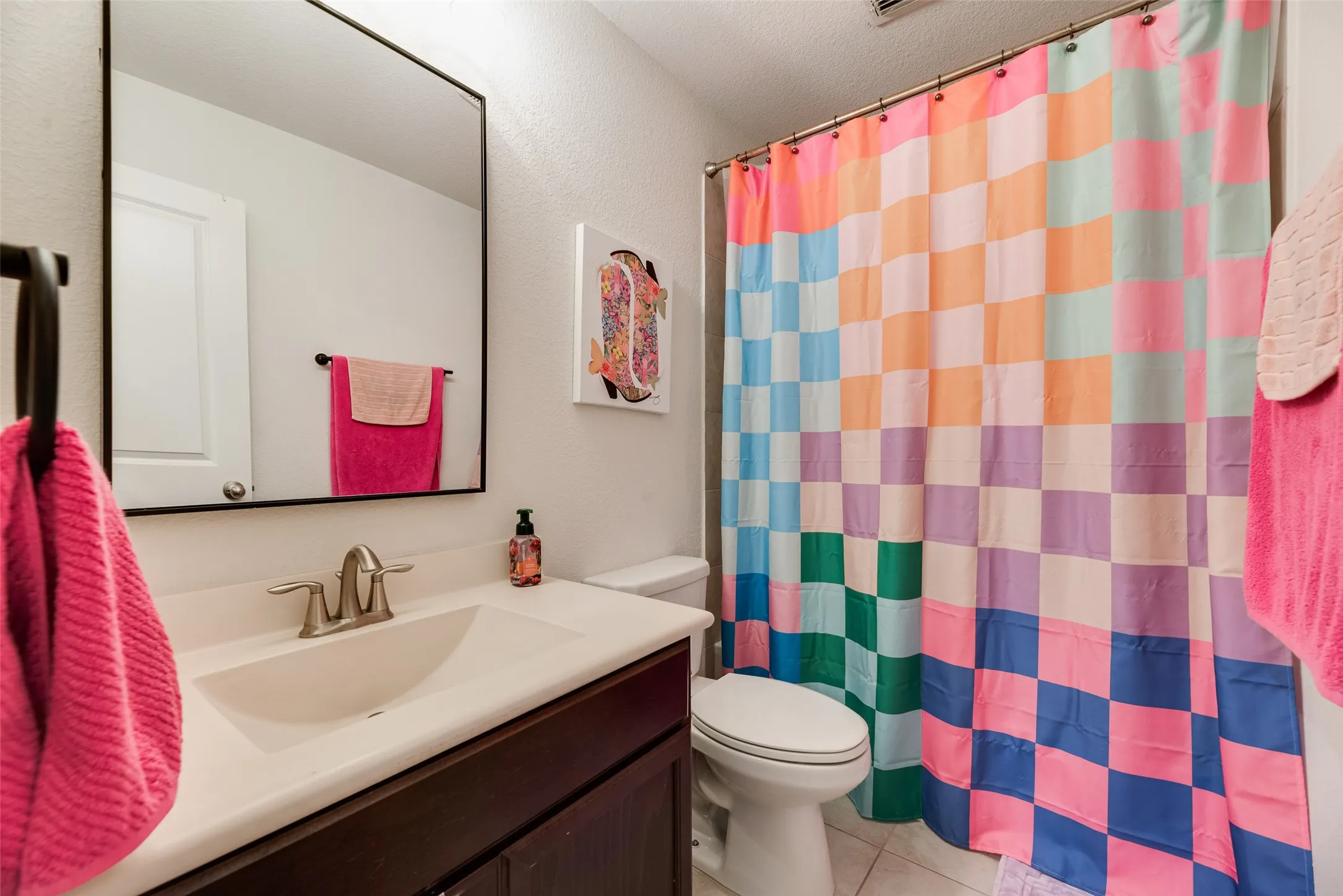Built-in vanity with a single basin sink, brushed nickel faucet, and undermount cabinetry