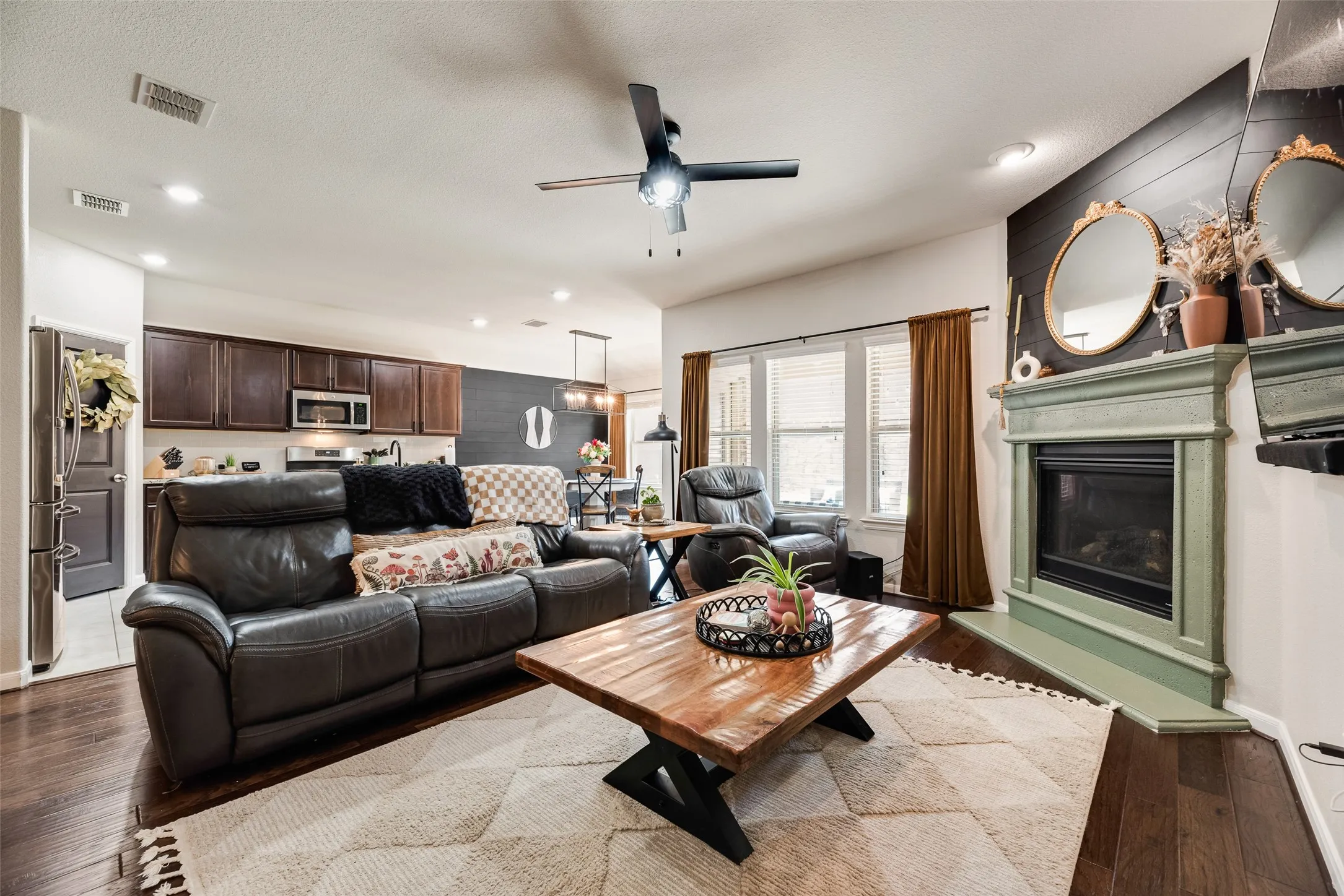 Recessed lighting, wood-finish flooring, and a ceiling fan with integrated lighting
