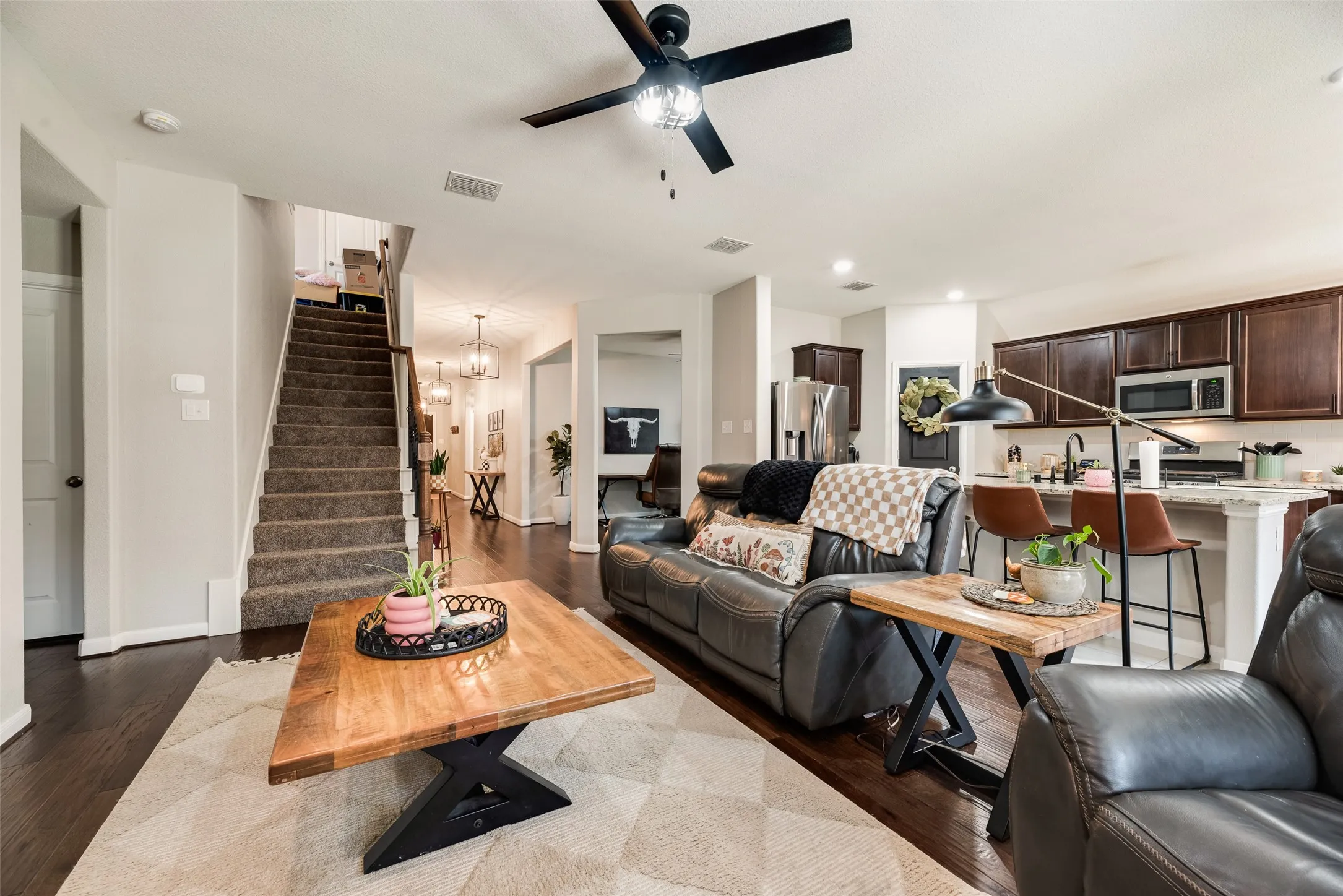 Dark wood-finish flooring complements light wall tones throughout