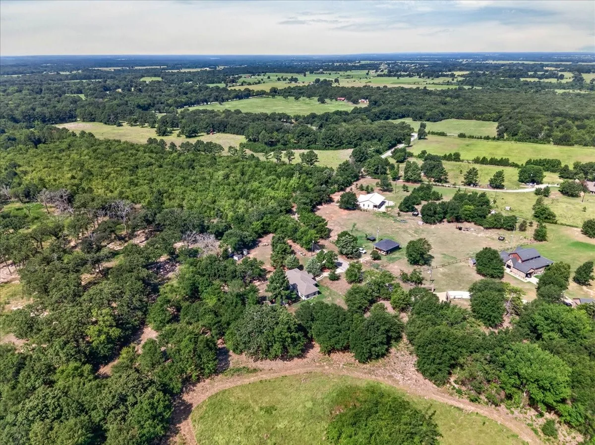 Expansive rural landscape featuring a mix of mature trees and open fields
