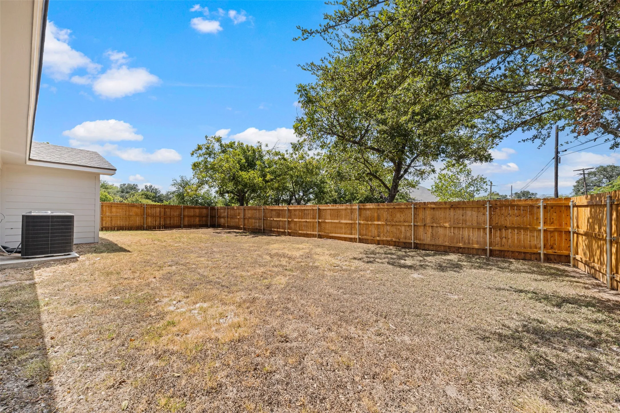 Expansive exterior space with a full privacy fence