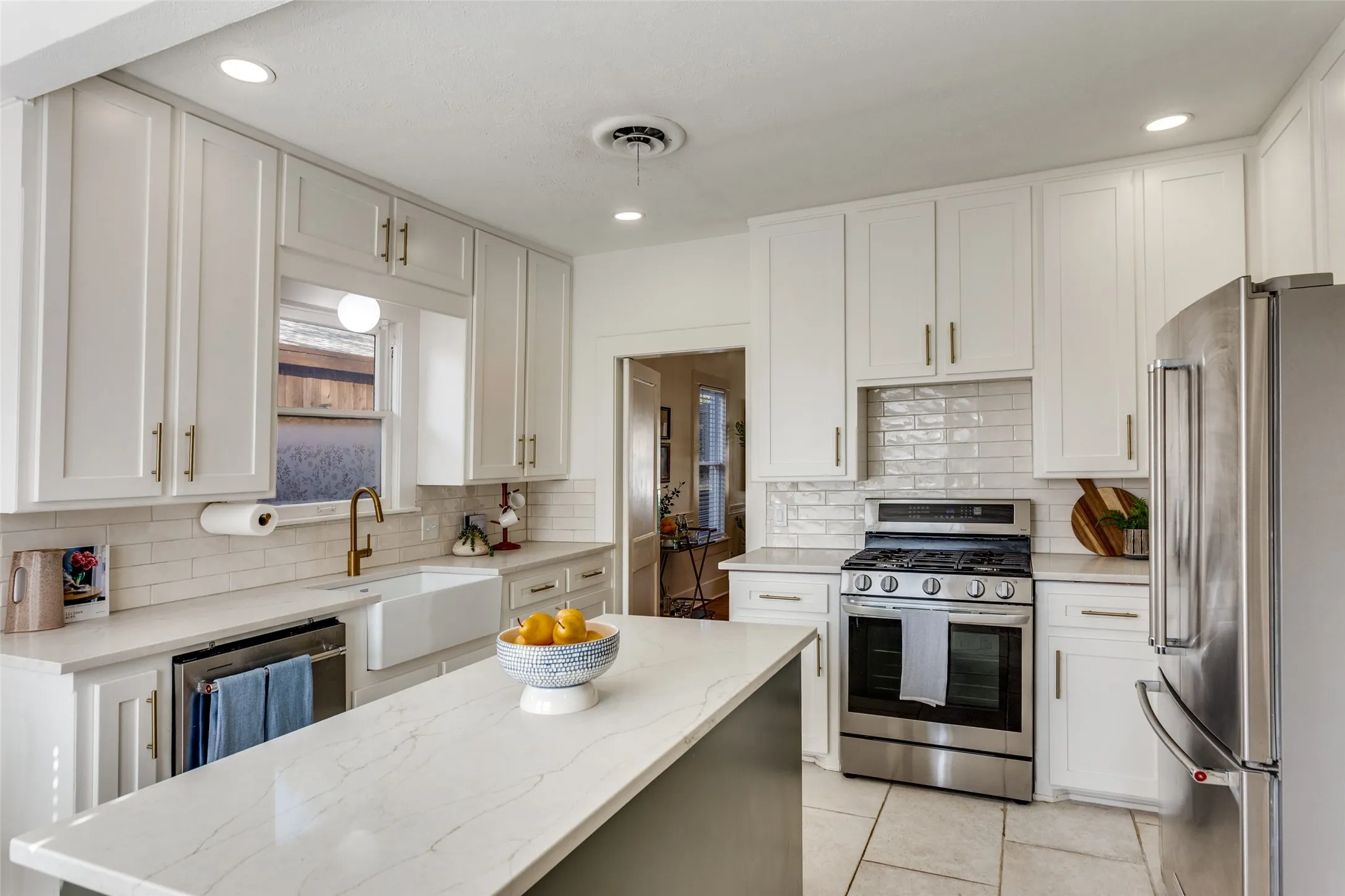 Updated kitchen island with custom cabinets, kitchen island, farmhouse sink and newer appliances.