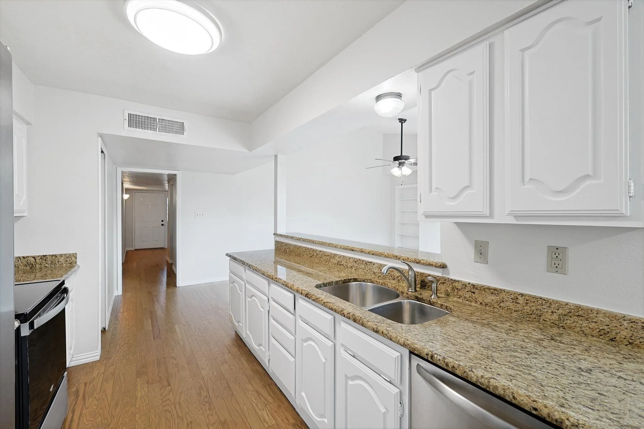 Kitchen with dual sinks, dishwasher.  Plenty of cabinet storage.