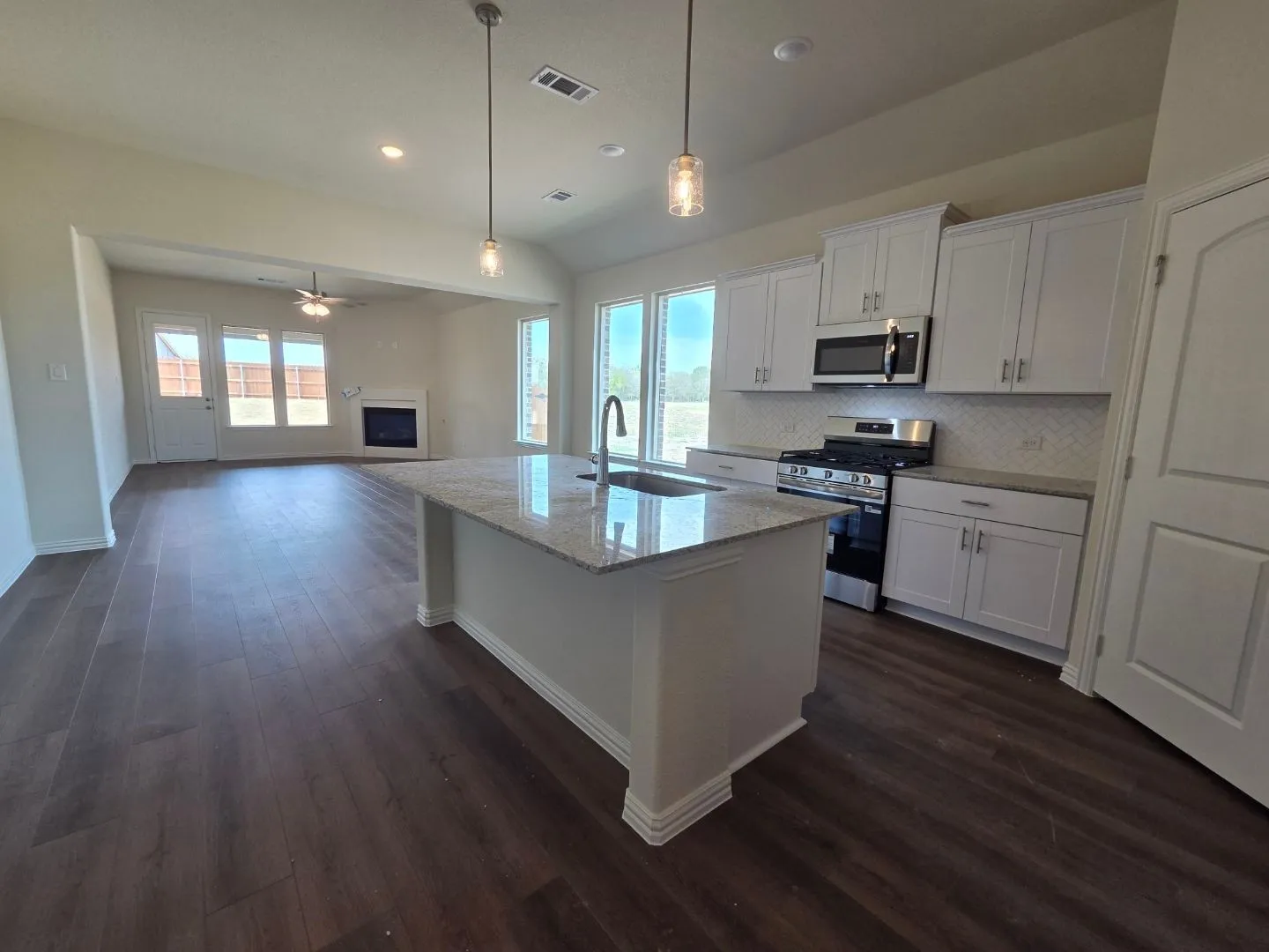 Kitchen island with a built-in sink and pendant lighting