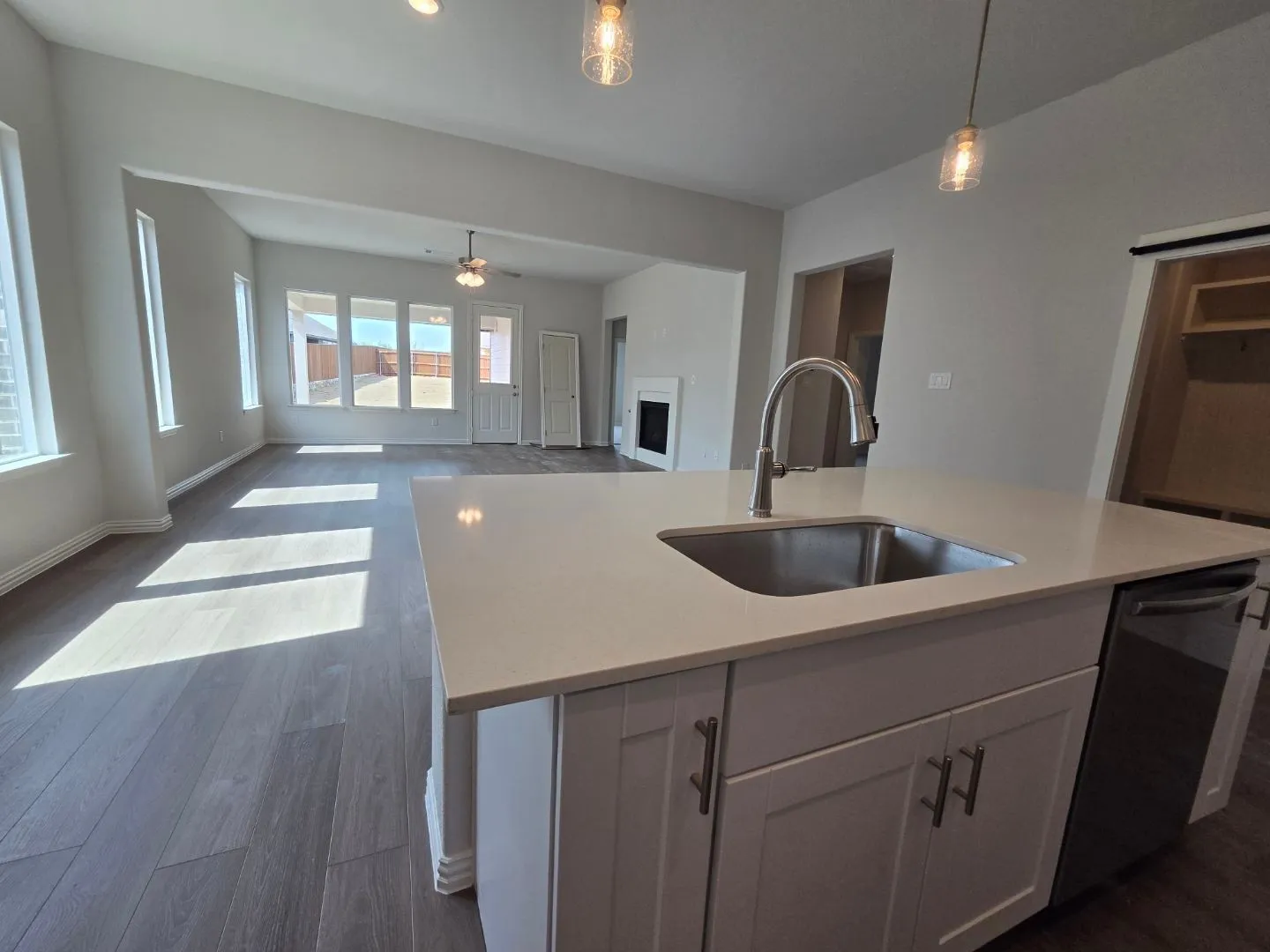 Kitchen island with an undermount sink, gooseneck faucet, and integrated dishwasher