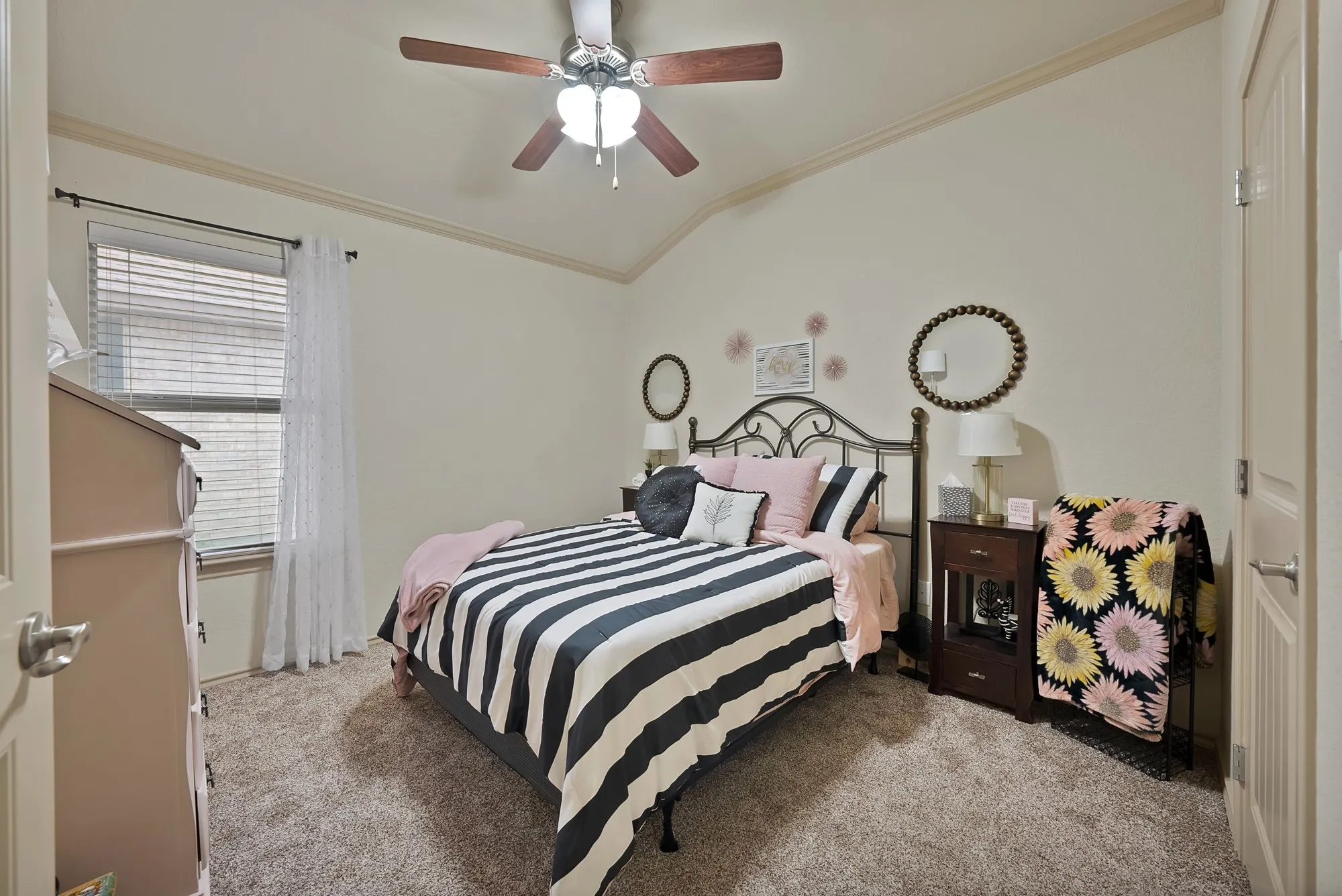 Vaulted ceiling featuring a ceiling fan, carpet flooring, and window with blinds