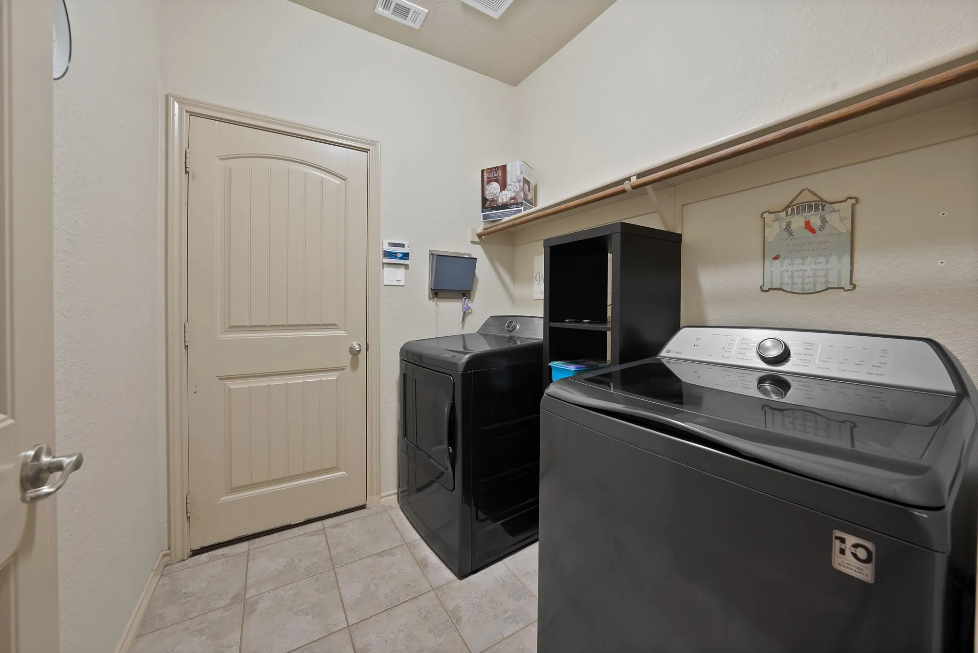 Tiled flooring, built-in shelving, and a sturdy hanging rod