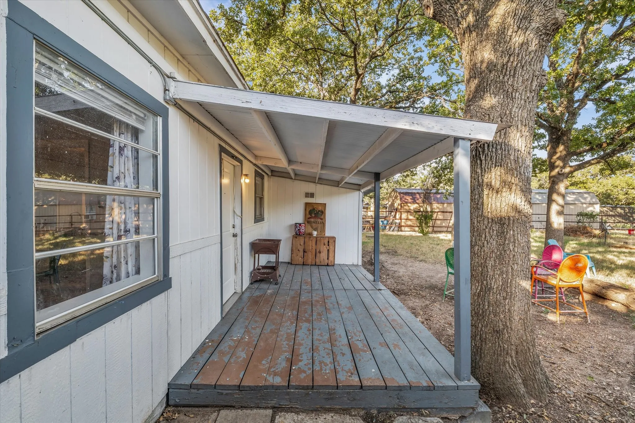 Covered porch with wood flooring and a solid exterior door