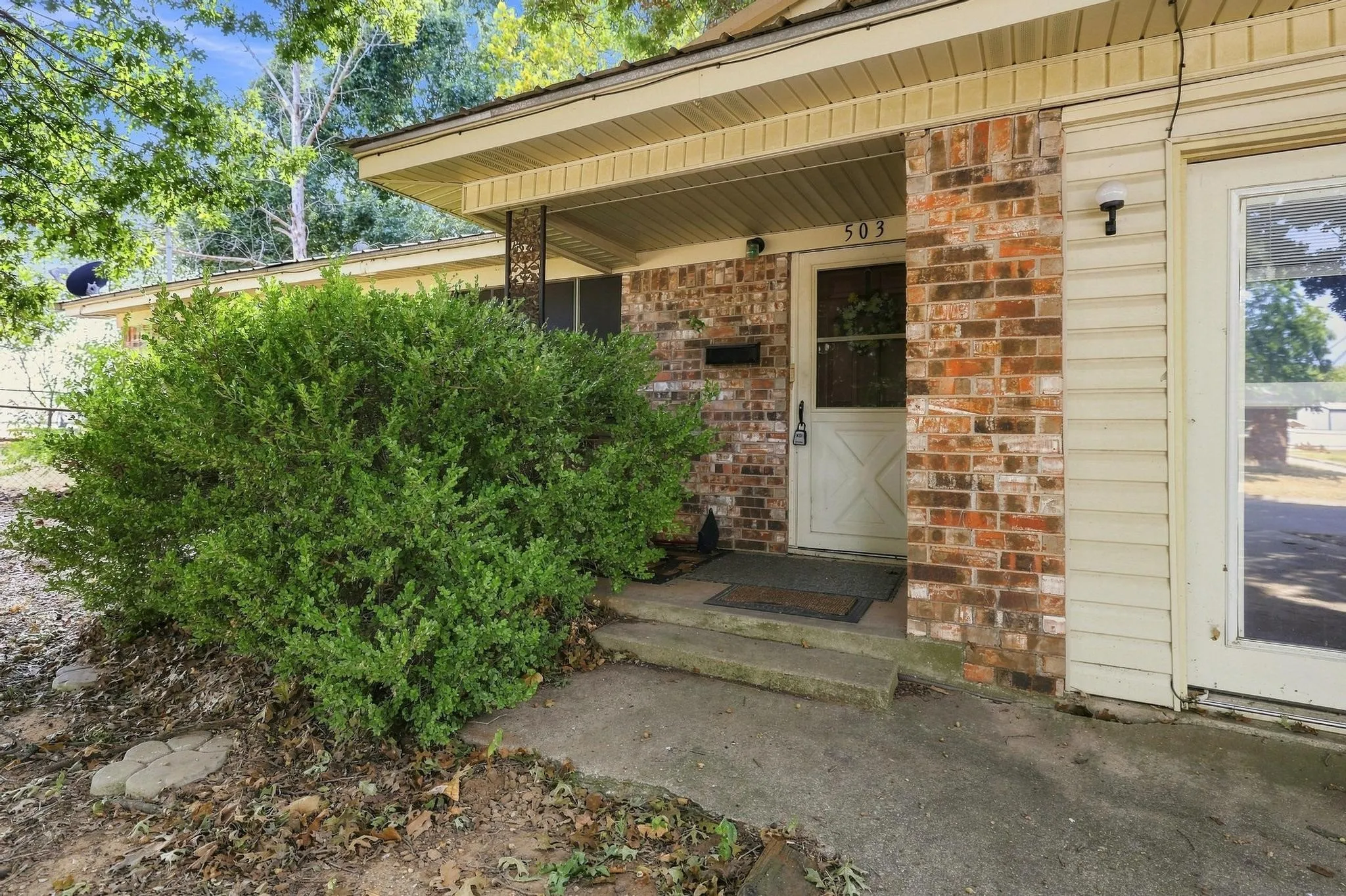 Brick and siding exterior with covered entry
