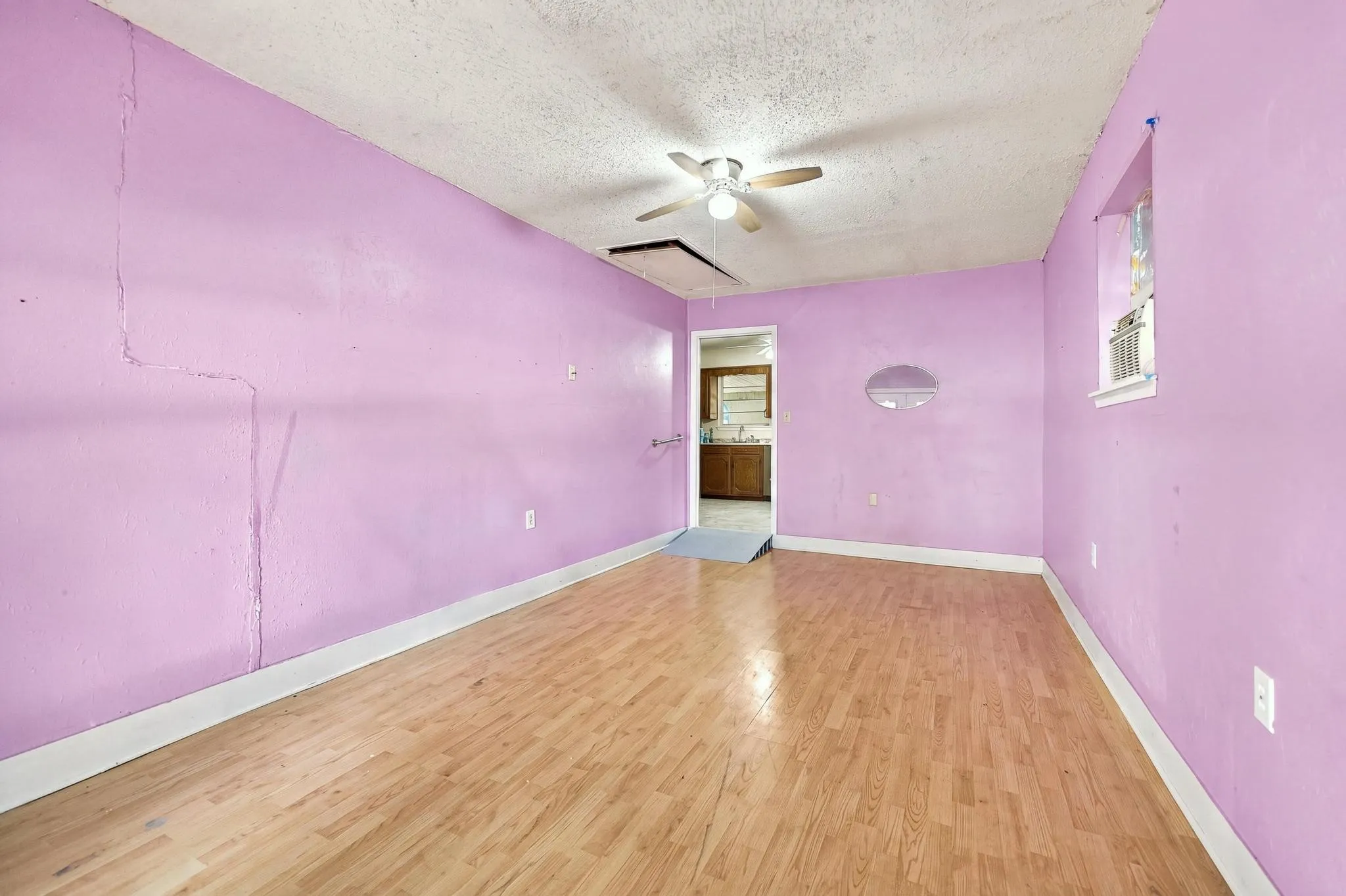 Wood-finish flooring with a ceiling fan light fixture