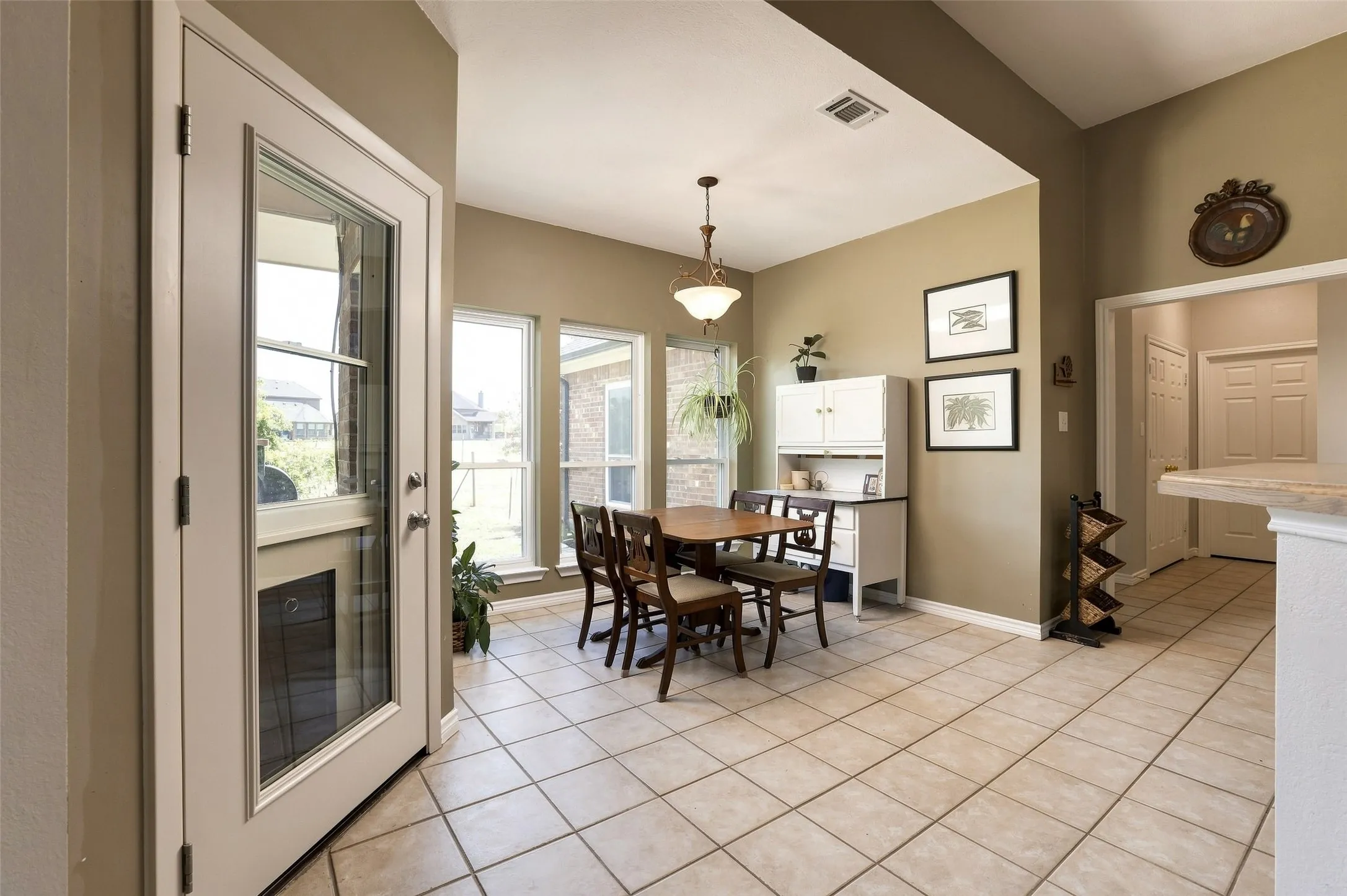 The breakfast room is filled with light from the recently replaced large windows
