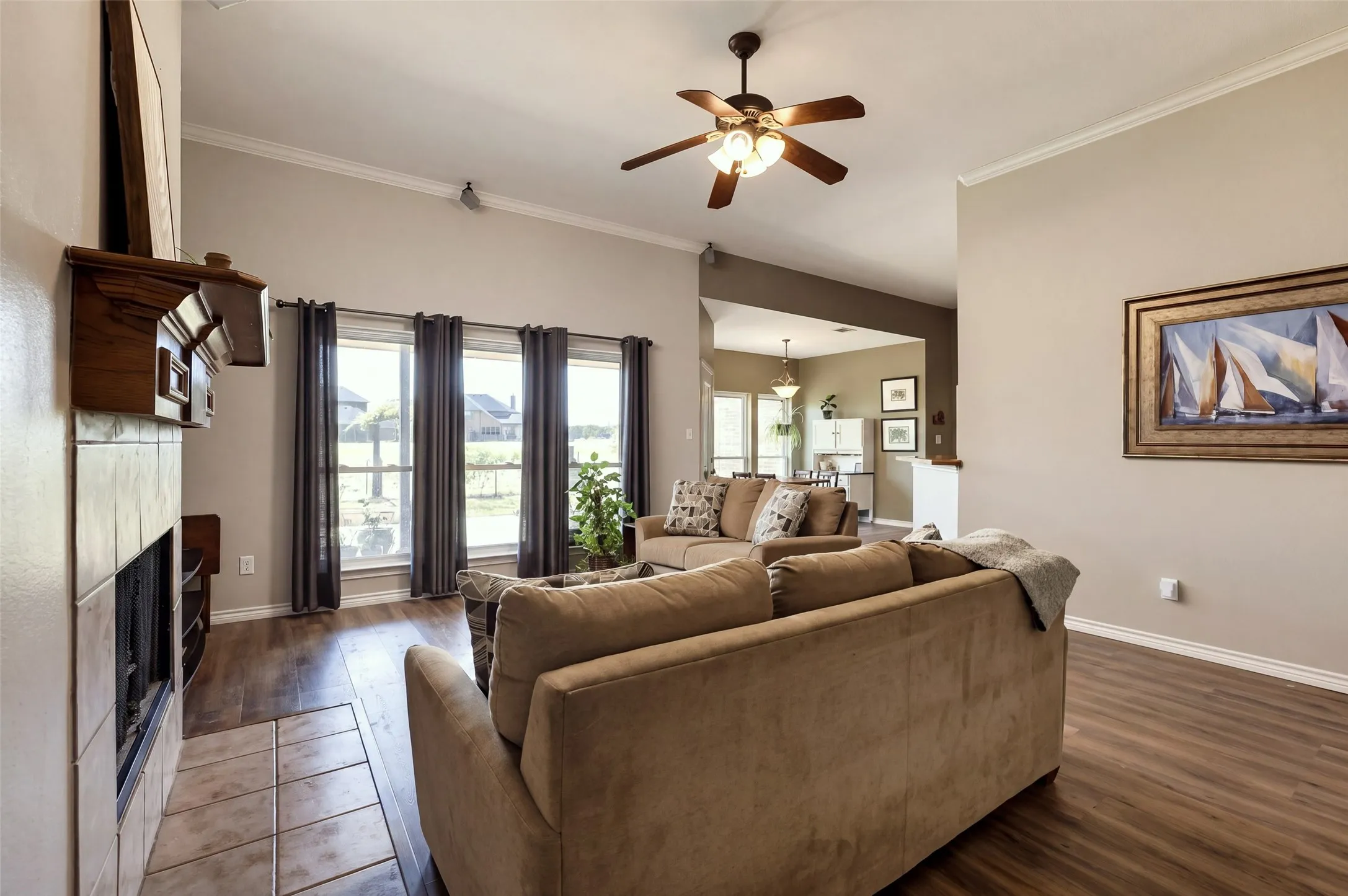 The living room has tall ceilings that let the light in