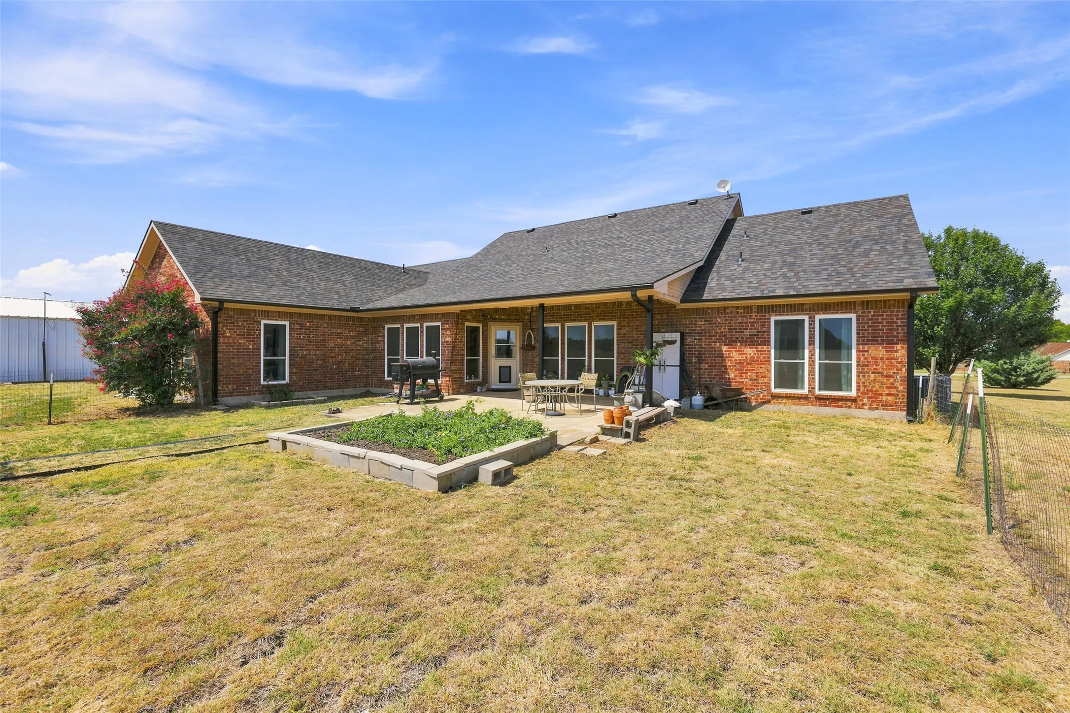 Outdoor living is easy with the covered patio and garden area