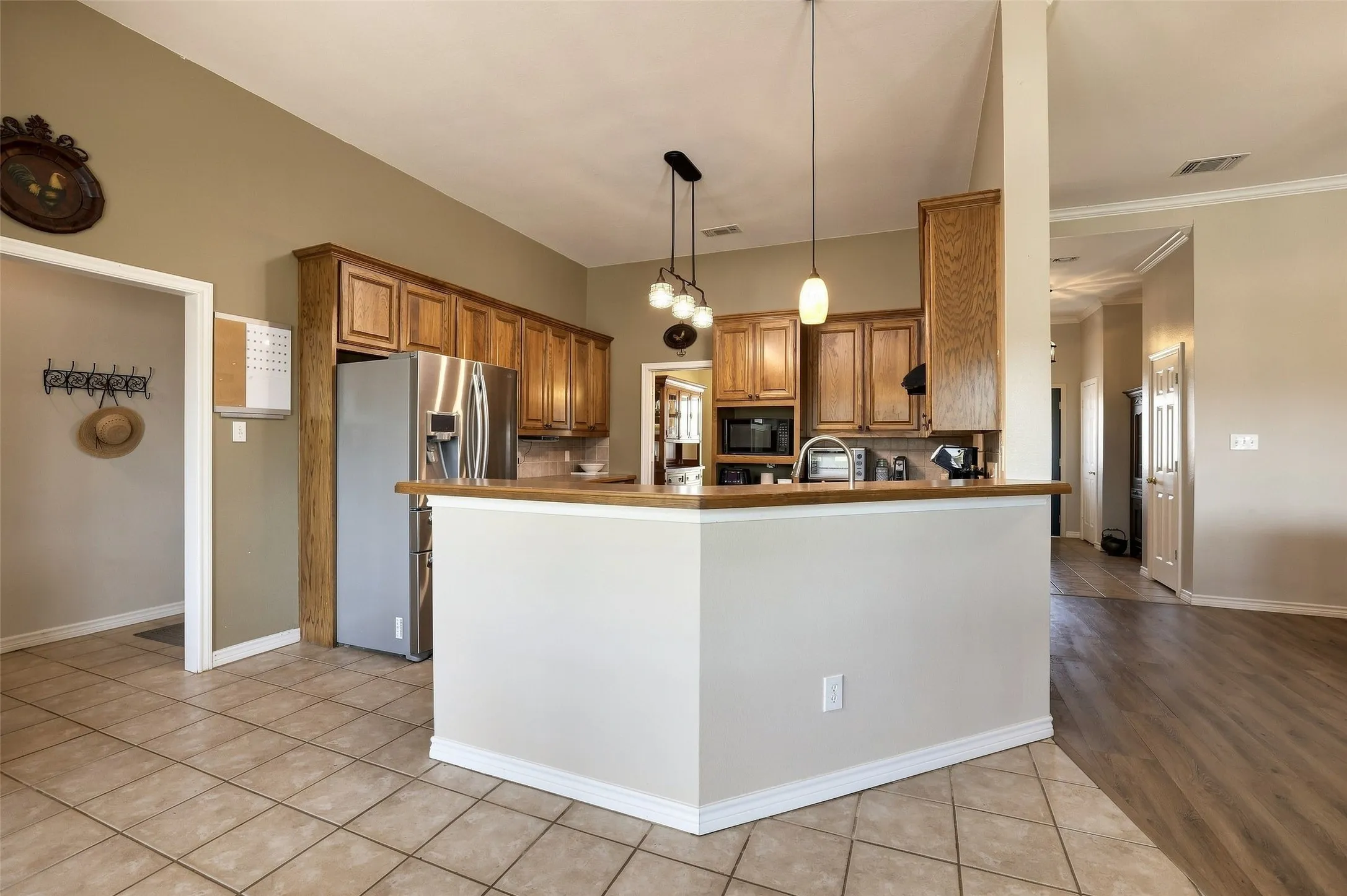 The kitchen has beautiful warm wood cabinets