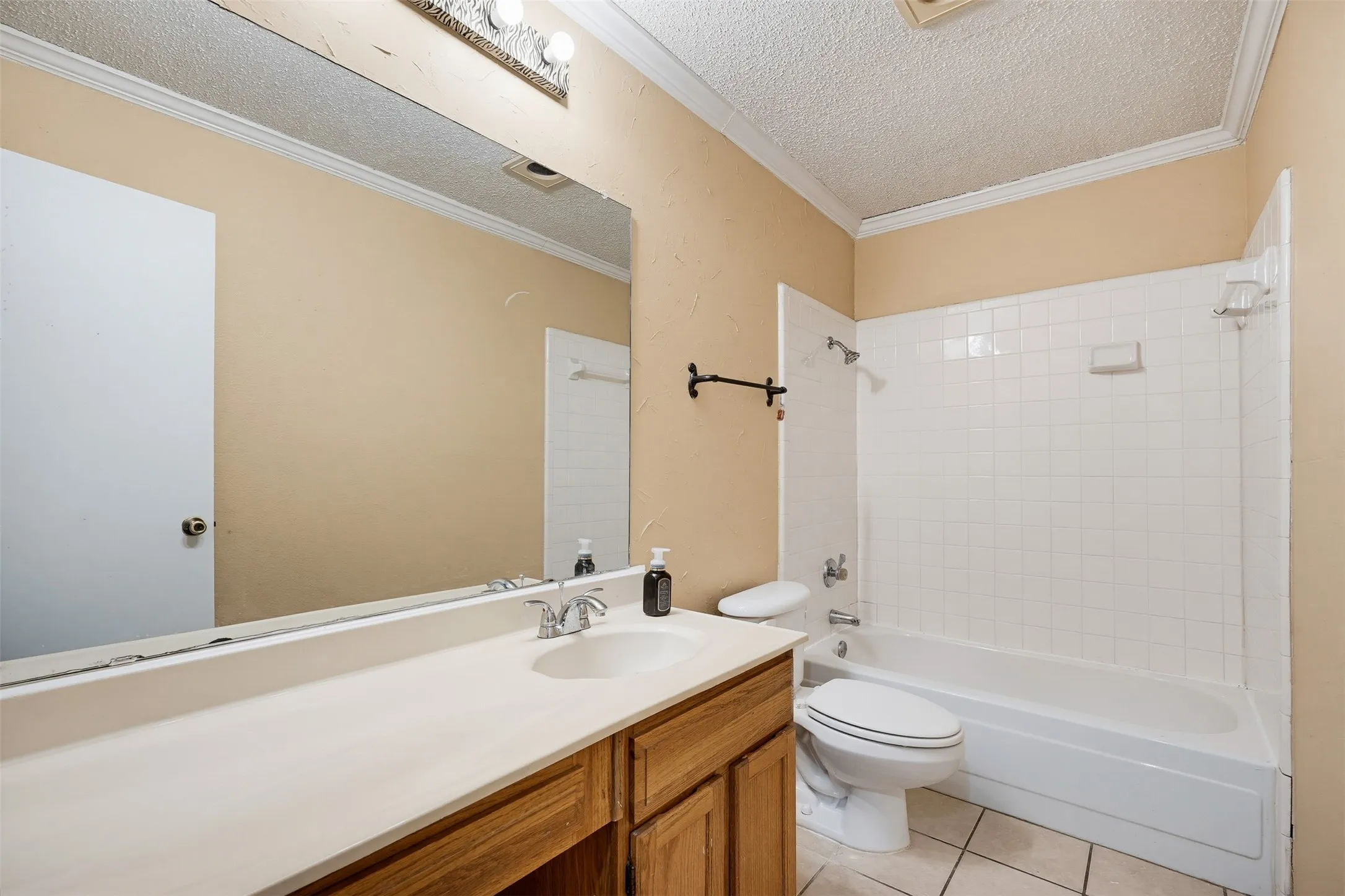 Wood-finish vanity with an integrated sink and chrome faucet
