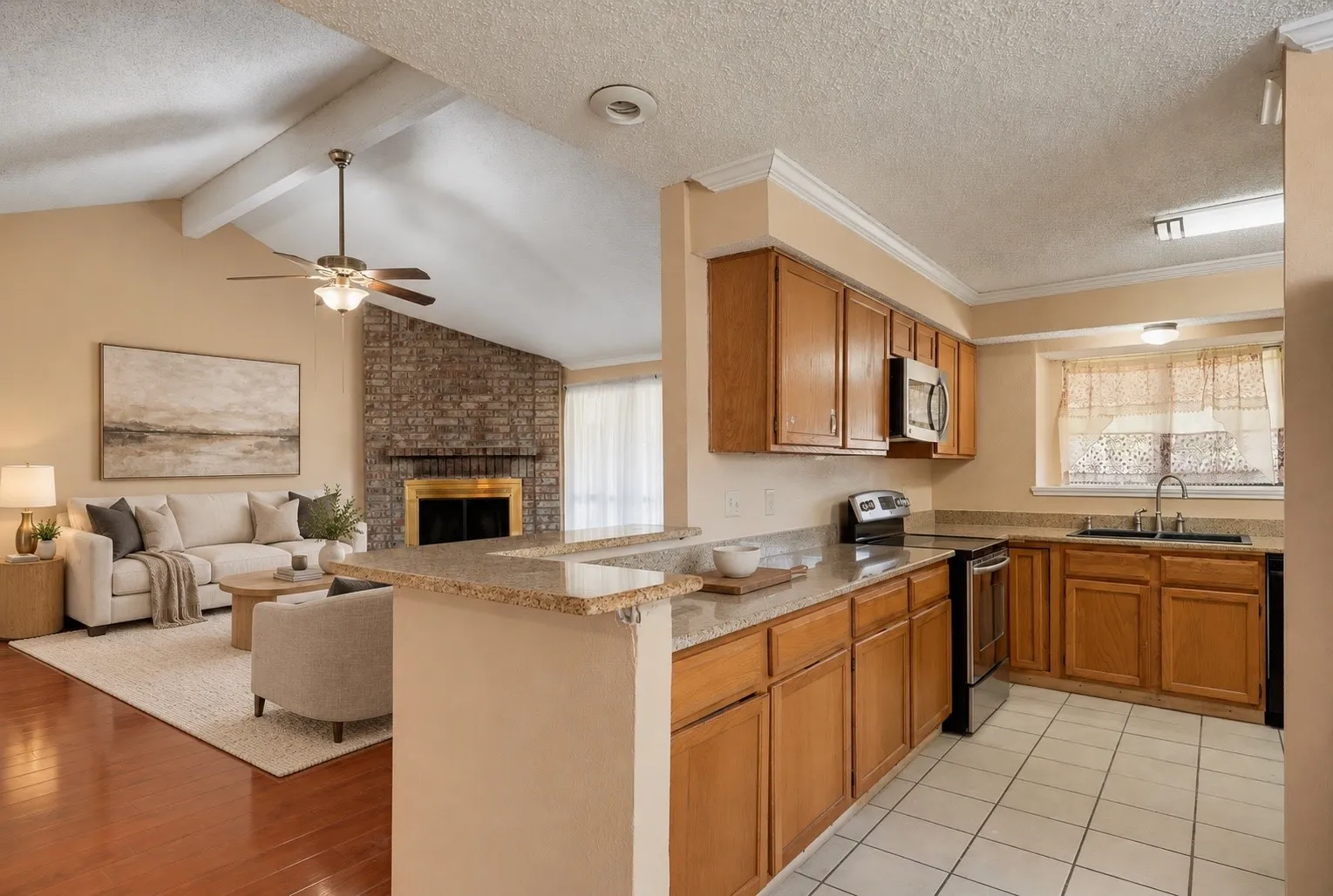 Kitchen featuring wood-finish cabinetry, light-toned countertops, and tile flooring
