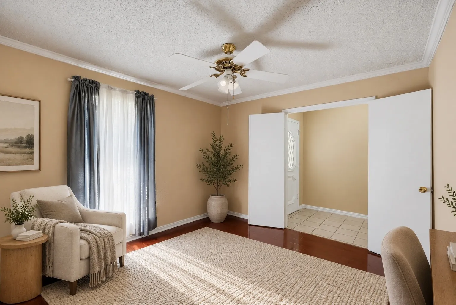 Hardwood-finish flooring, crown molding, and a ceiling fan with integrated lighting