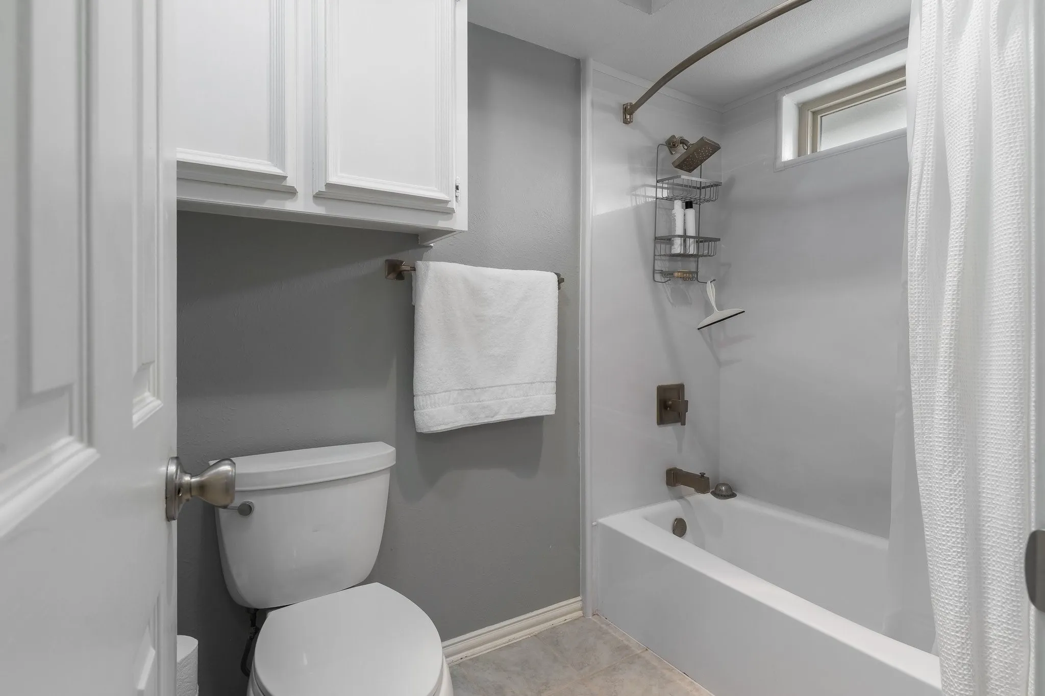 White overhead cabinetry provides storage