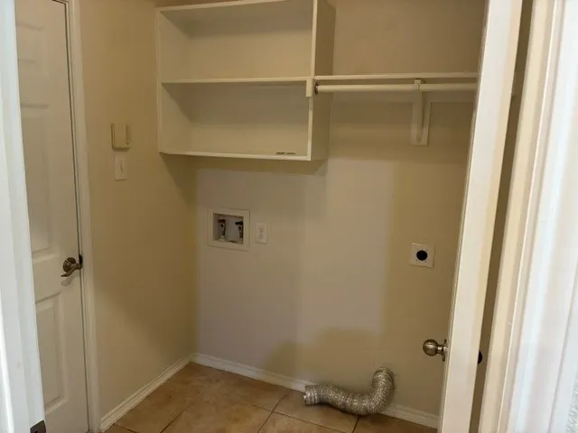 Built-in shelving, integrated clothes rod, and tile flooring