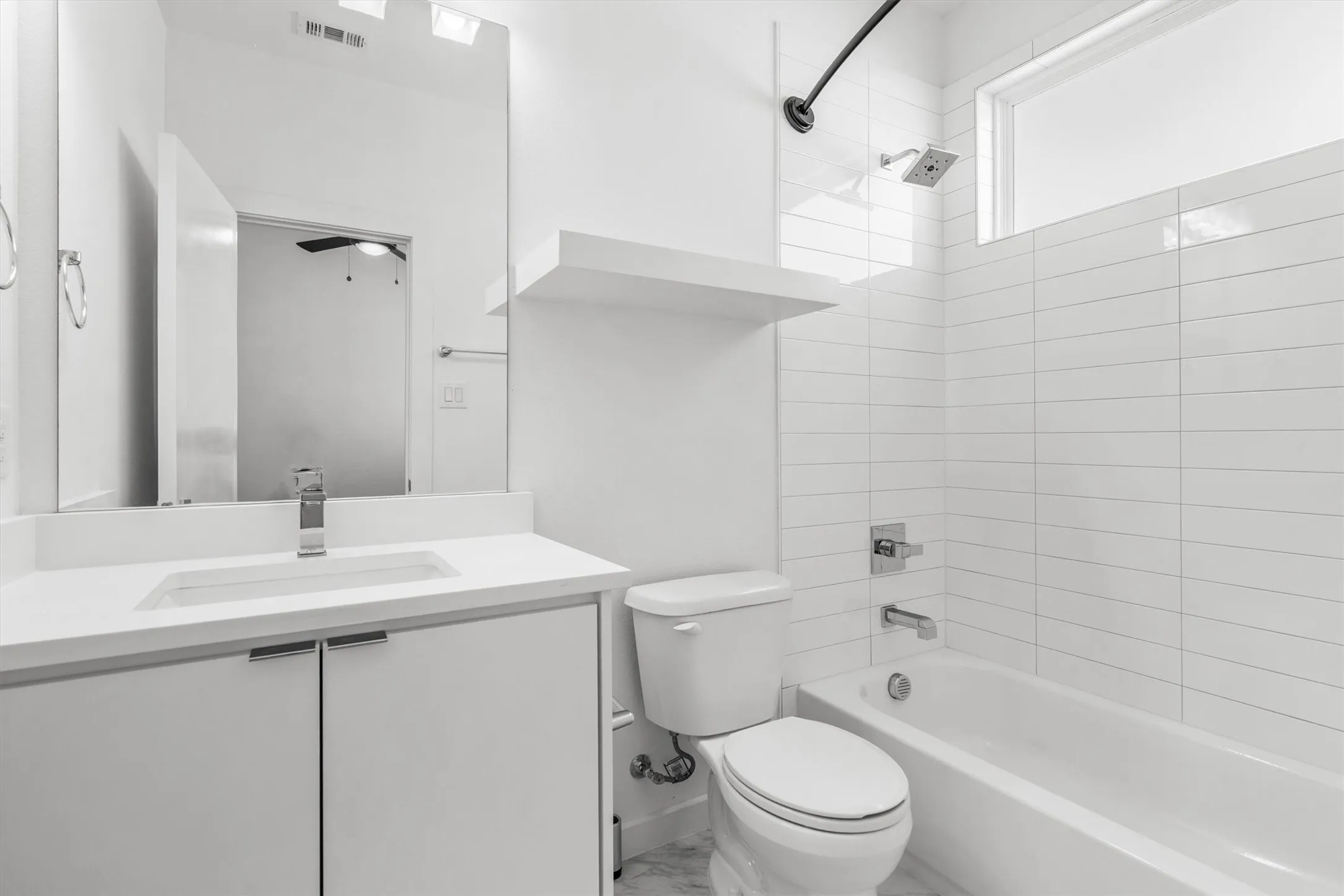 Modern vanity with an integrated sink, polished chrome faucet, and white countertop