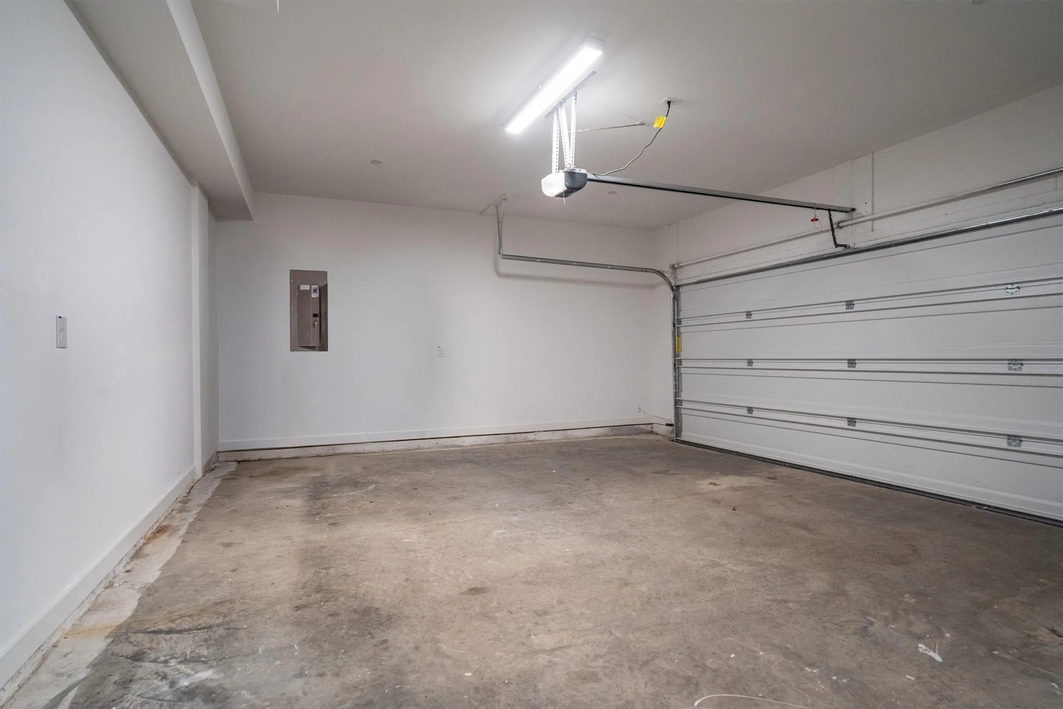 Attached garage with an overhead door and automatic opener
