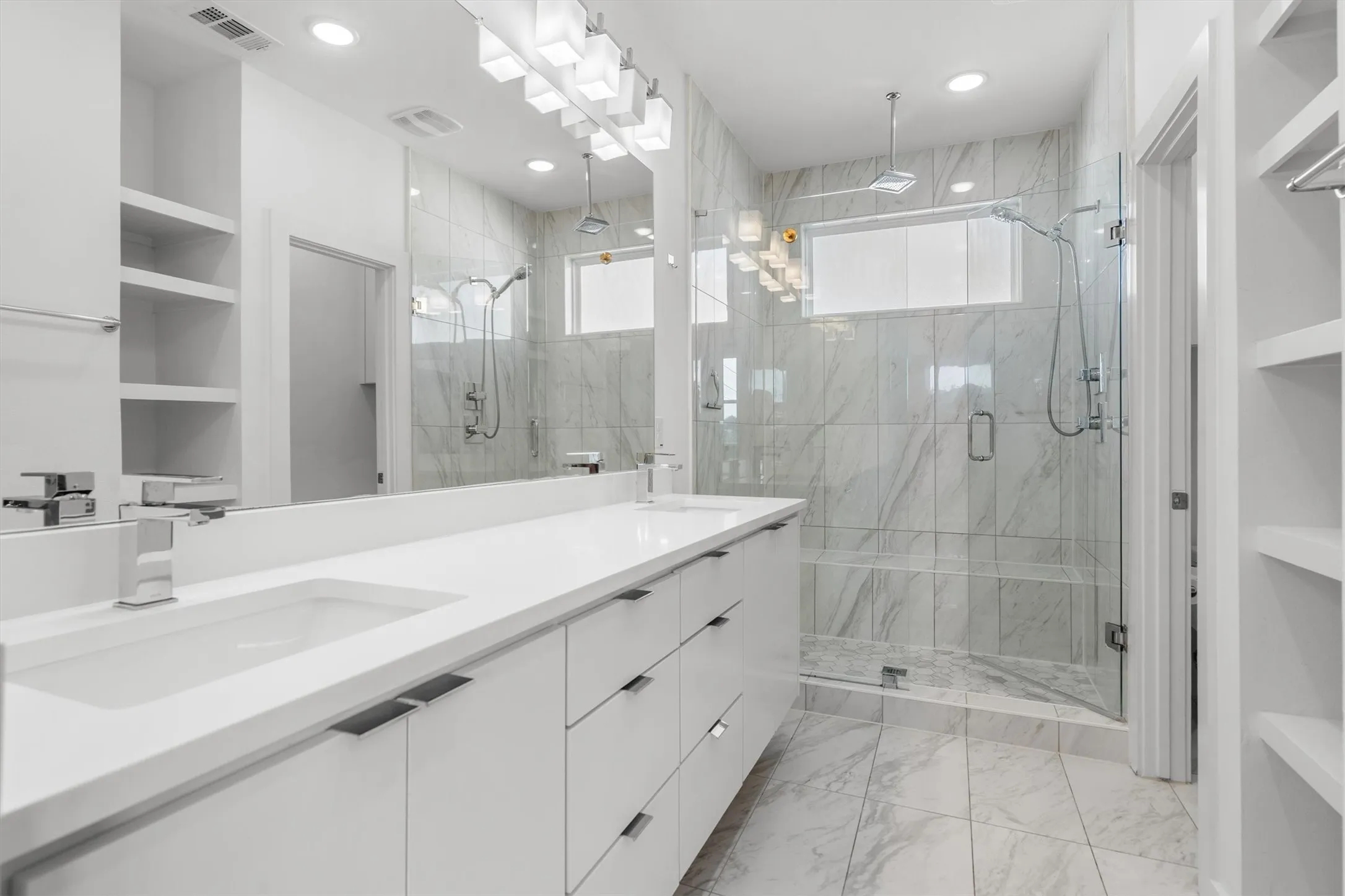 Double vanity with integrated sinks and polished chrome fixtures