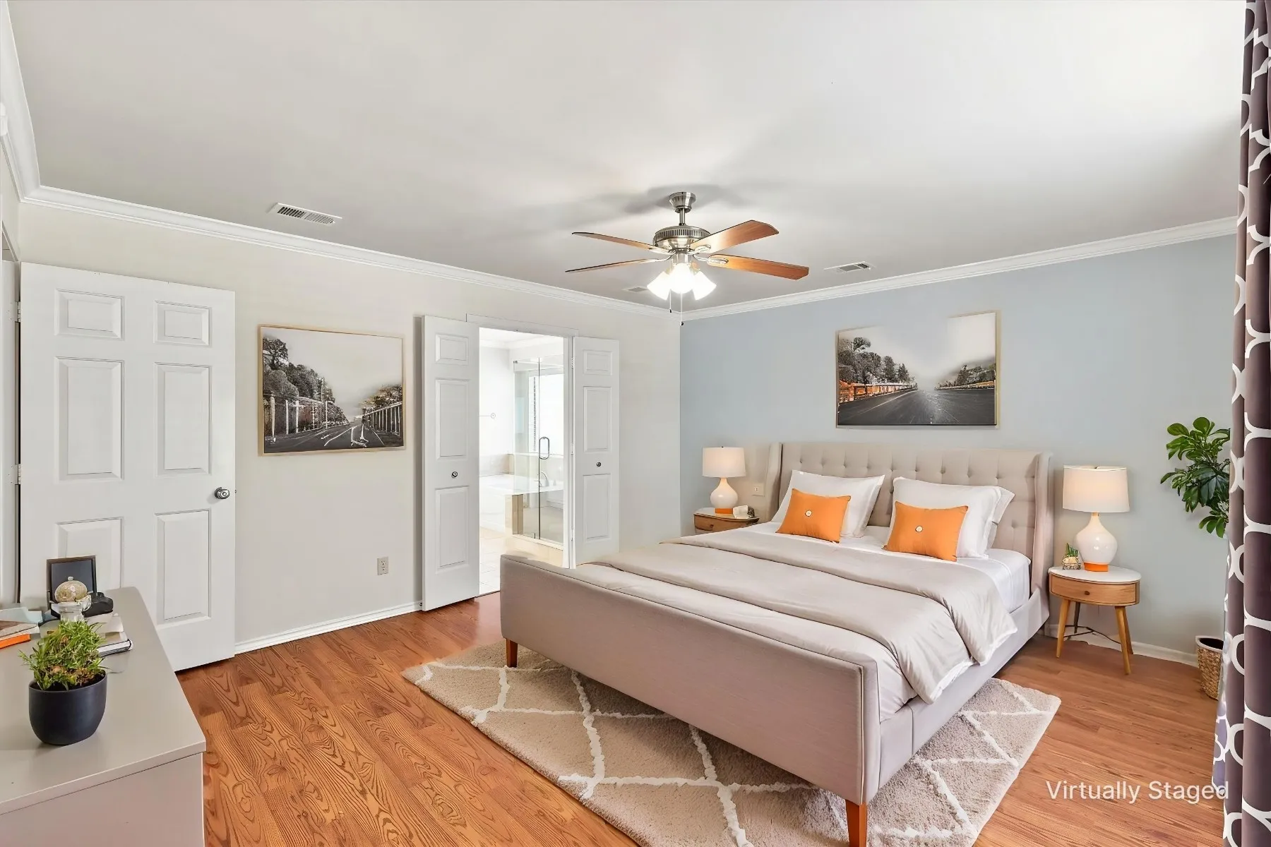 Wood-finish flooring, crown molding, and a ceiling fan with integrated lighting