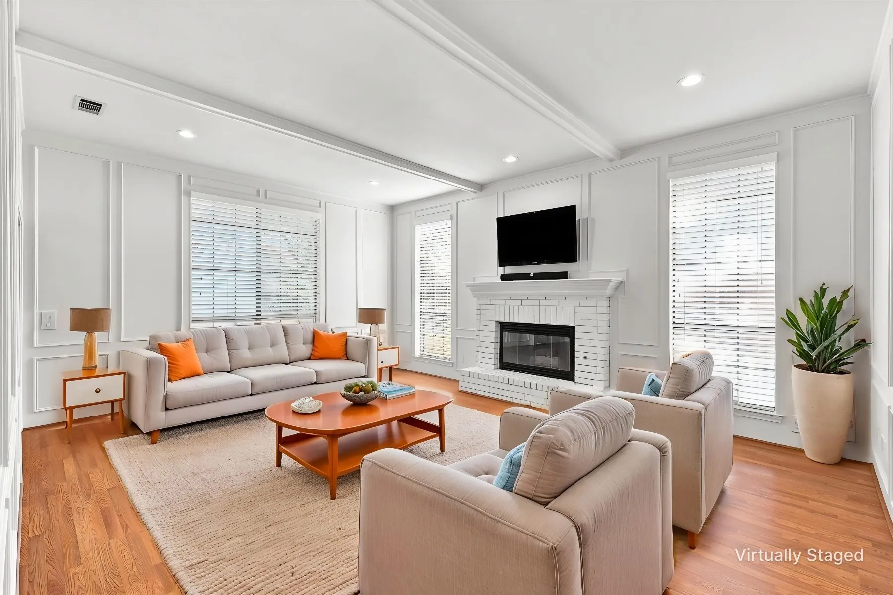 Wood-finish flooring, white brick fireplace, recessed lighting, white wall paneling, and white window blinds