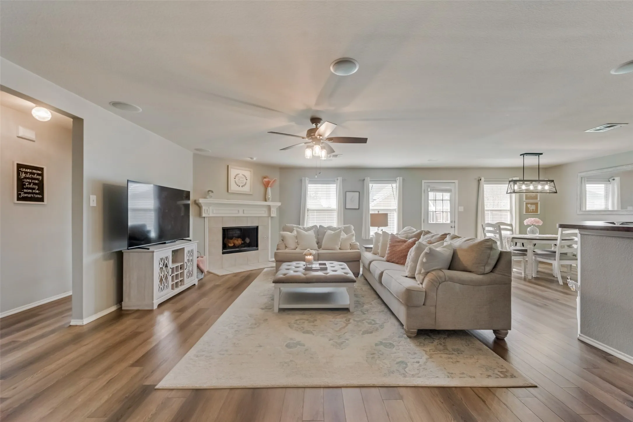 Wood-finish flooring, recessed lighting, and a ceiling fan