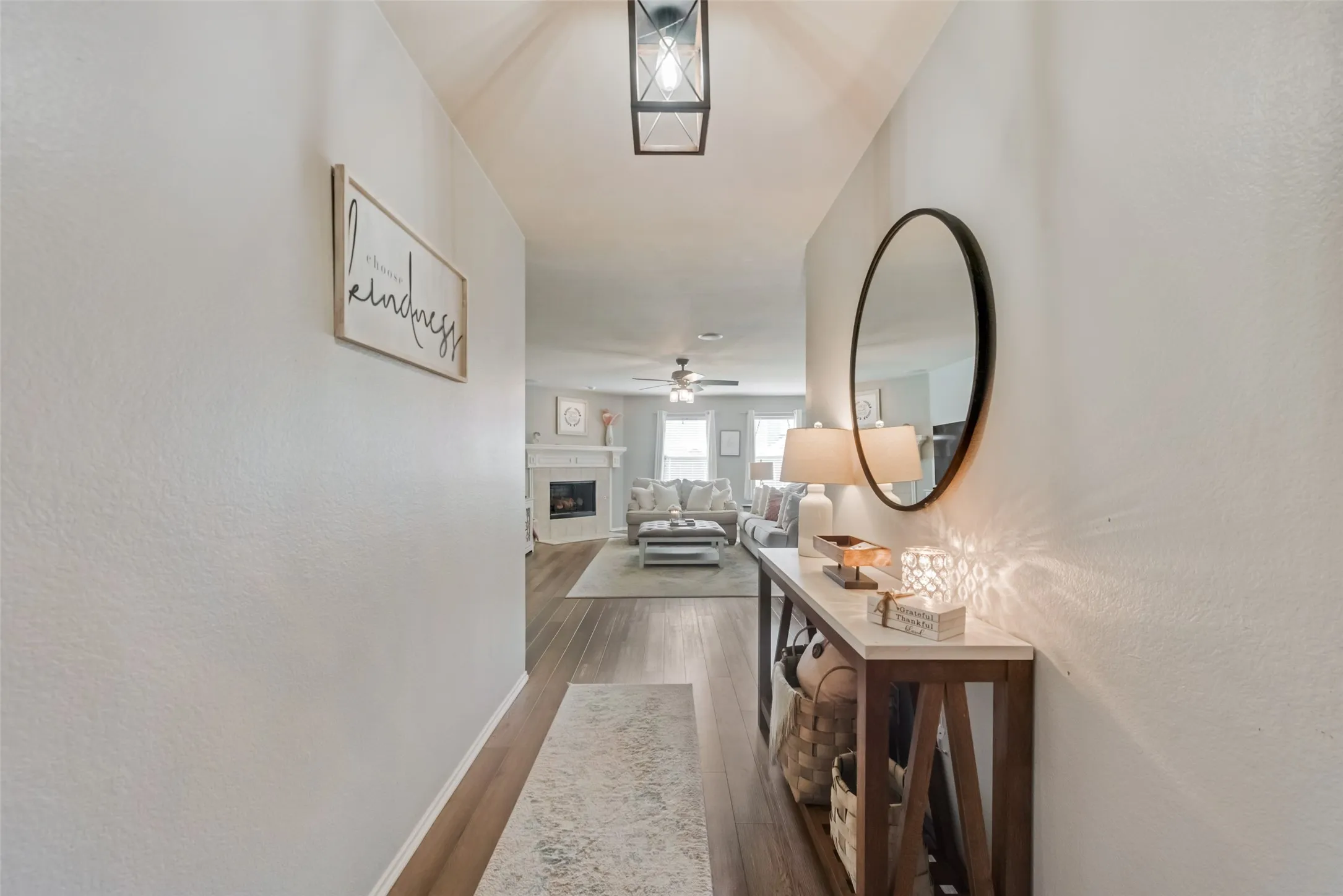 Hallway featuring wood-finish flooring and an overhead lantern-style light fixture