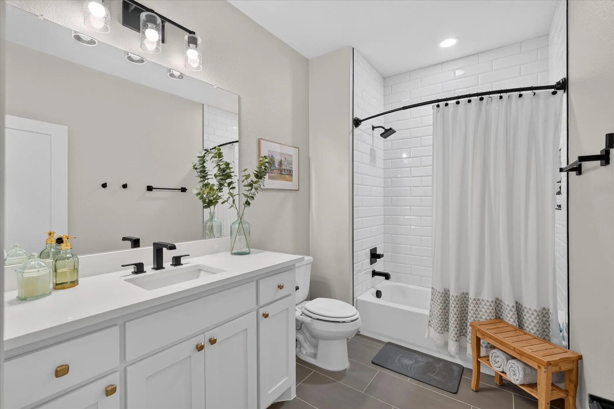 White vanity with a solid surface countertop and undermount sink