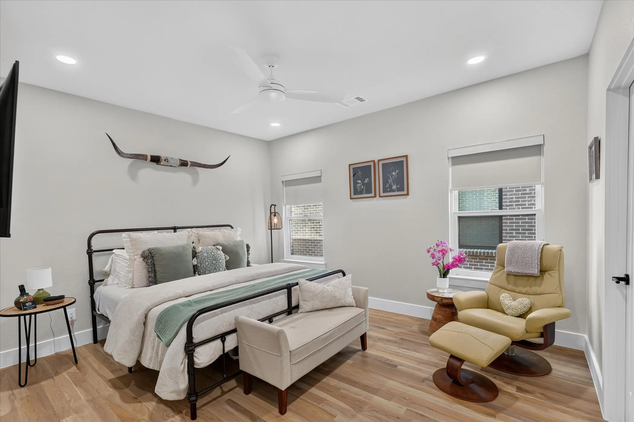 Recessed lighting, wood-finish flooring, and a ceiling fan