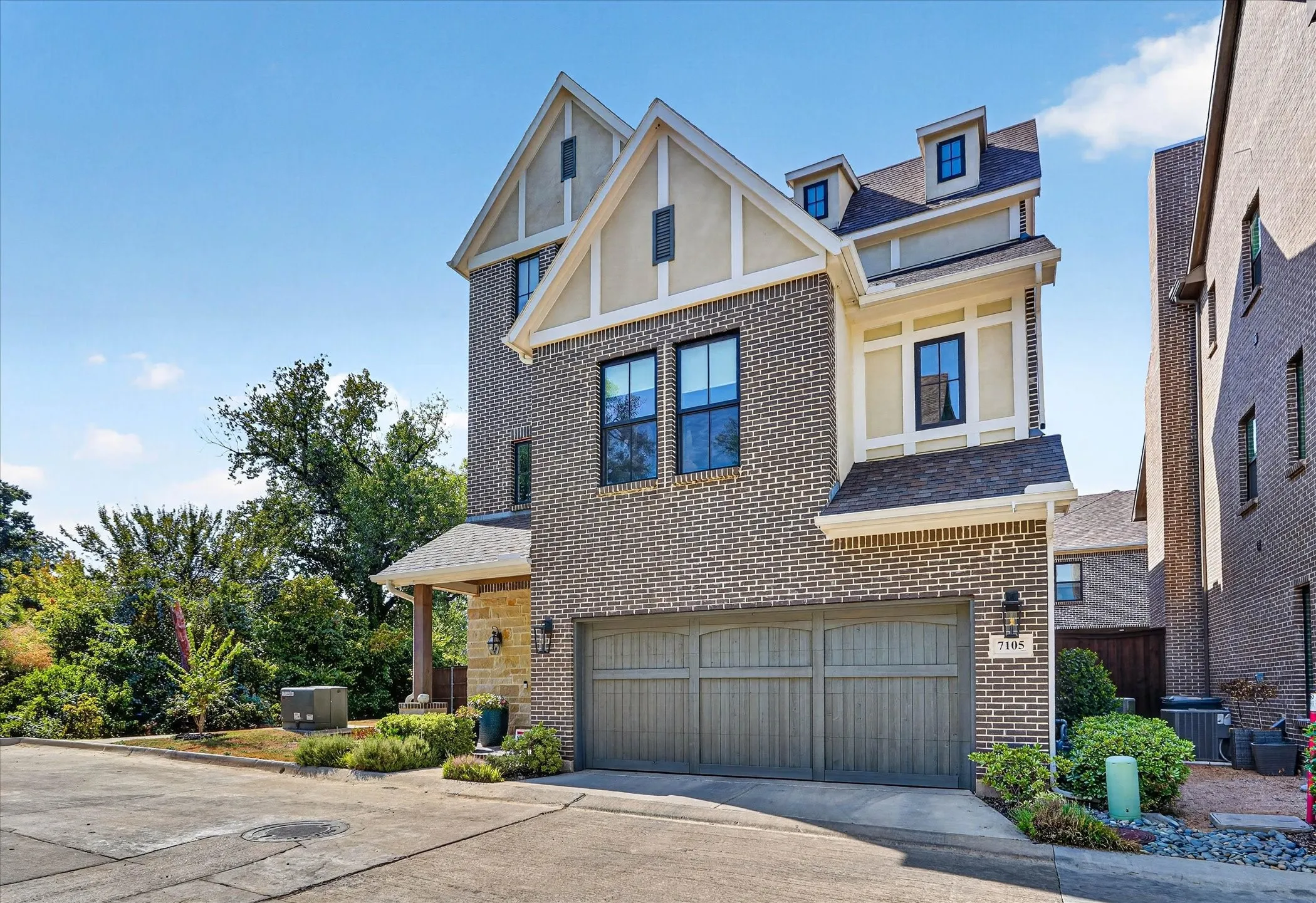Brick exterior with stone accents and a gabled roofline