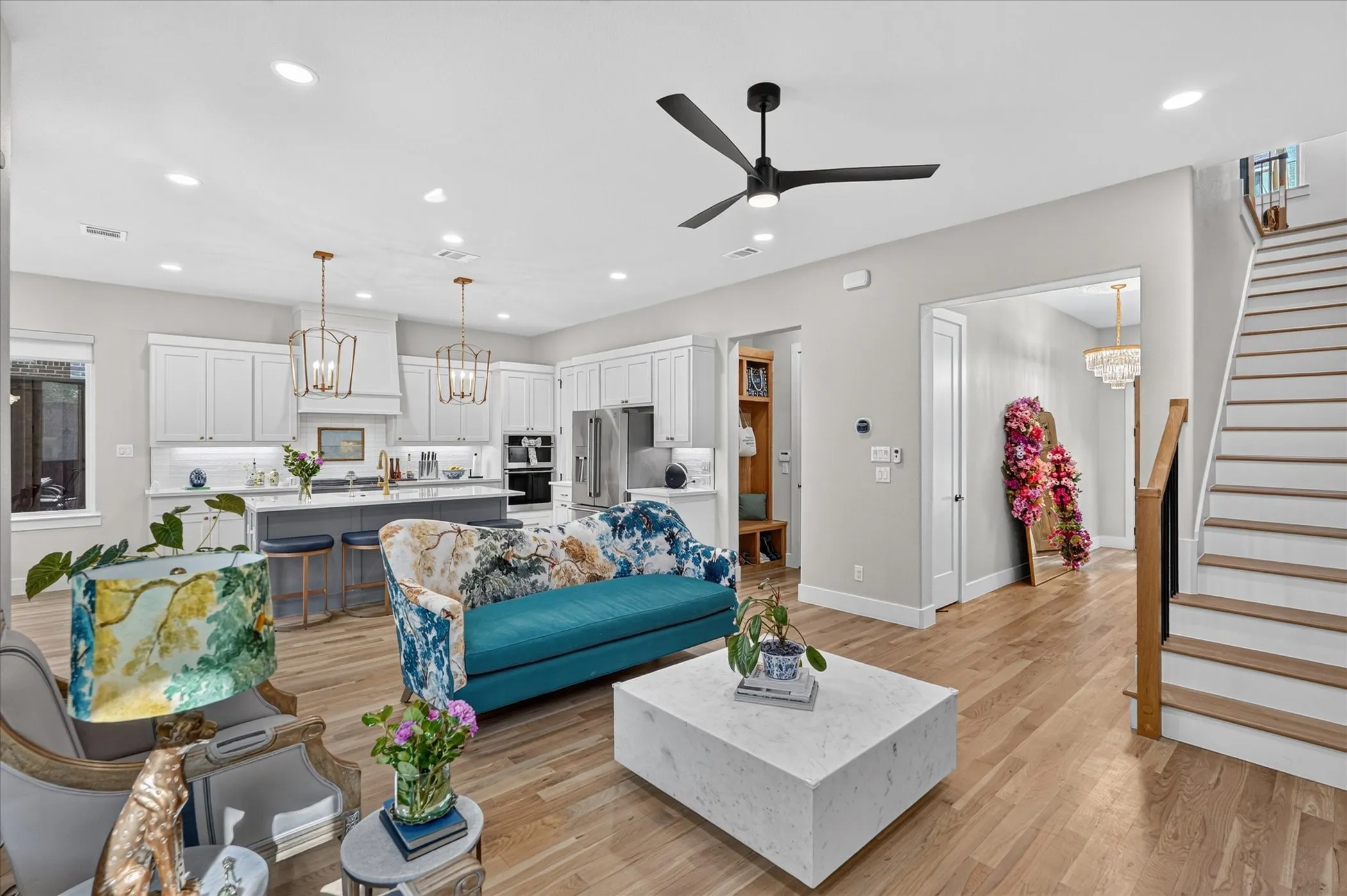 Open-concept living space featuring wood-finish flooring, recessed lighting, and a modern ceiling fan