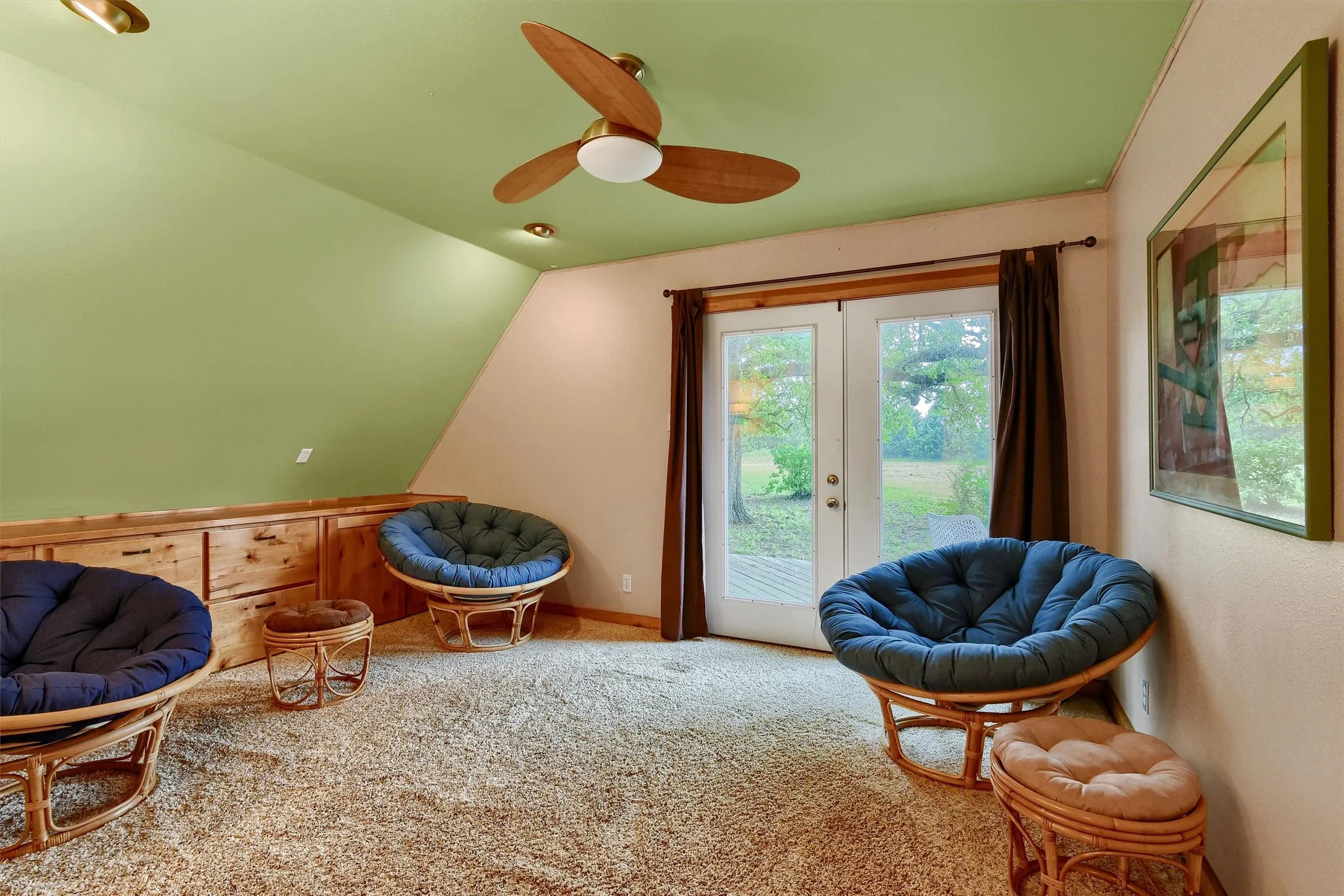 Sitting room with carpet flooring, lofted ceiling, ceiling fan, and french doors