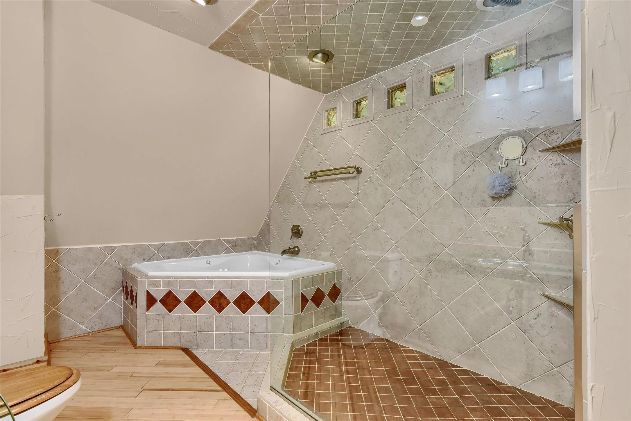 Bathroom featuring tile walls, independent shower and bath, wood-type flooring, and toilet