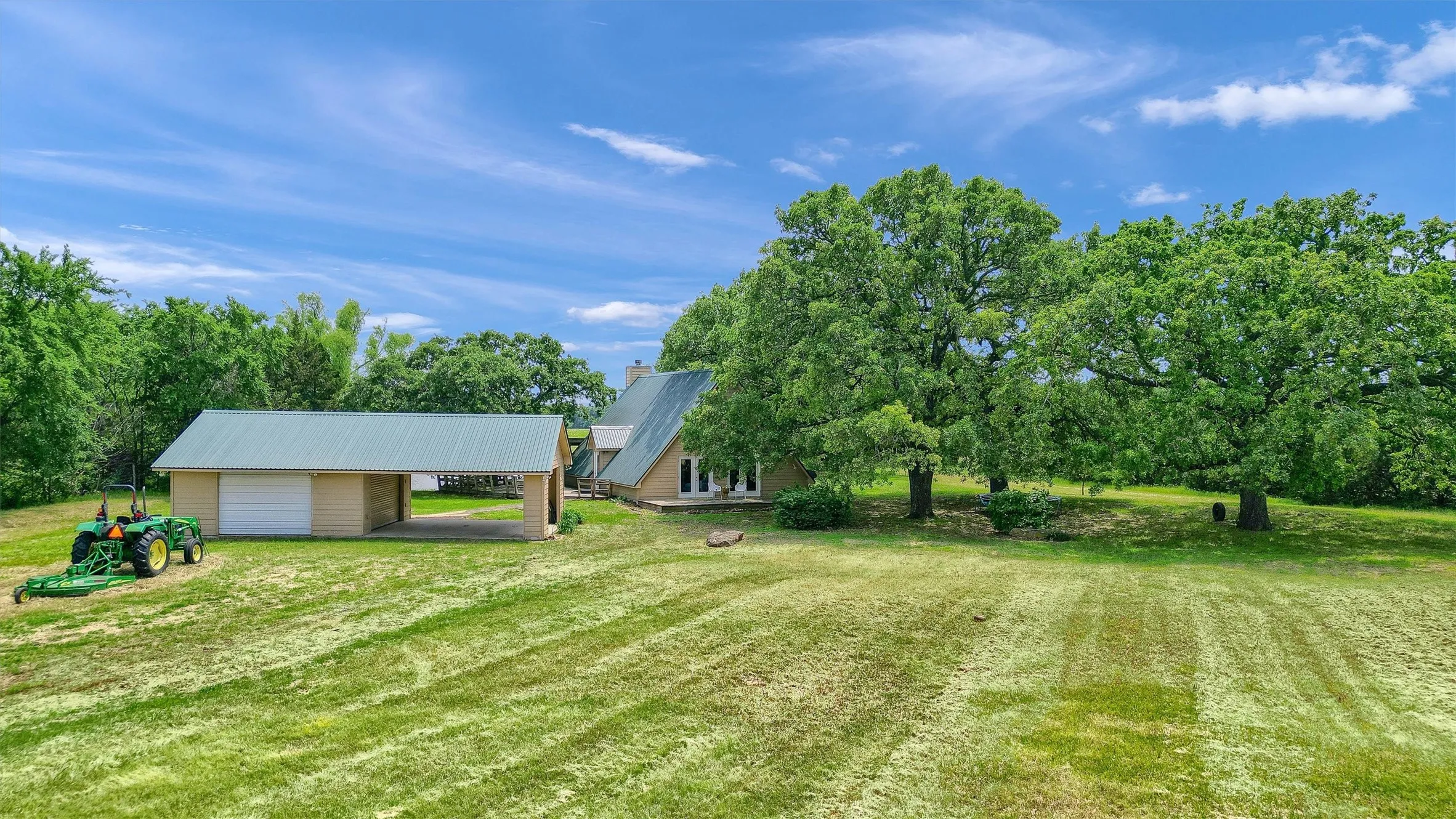 View of yard featuring a garage and an outdoor structure