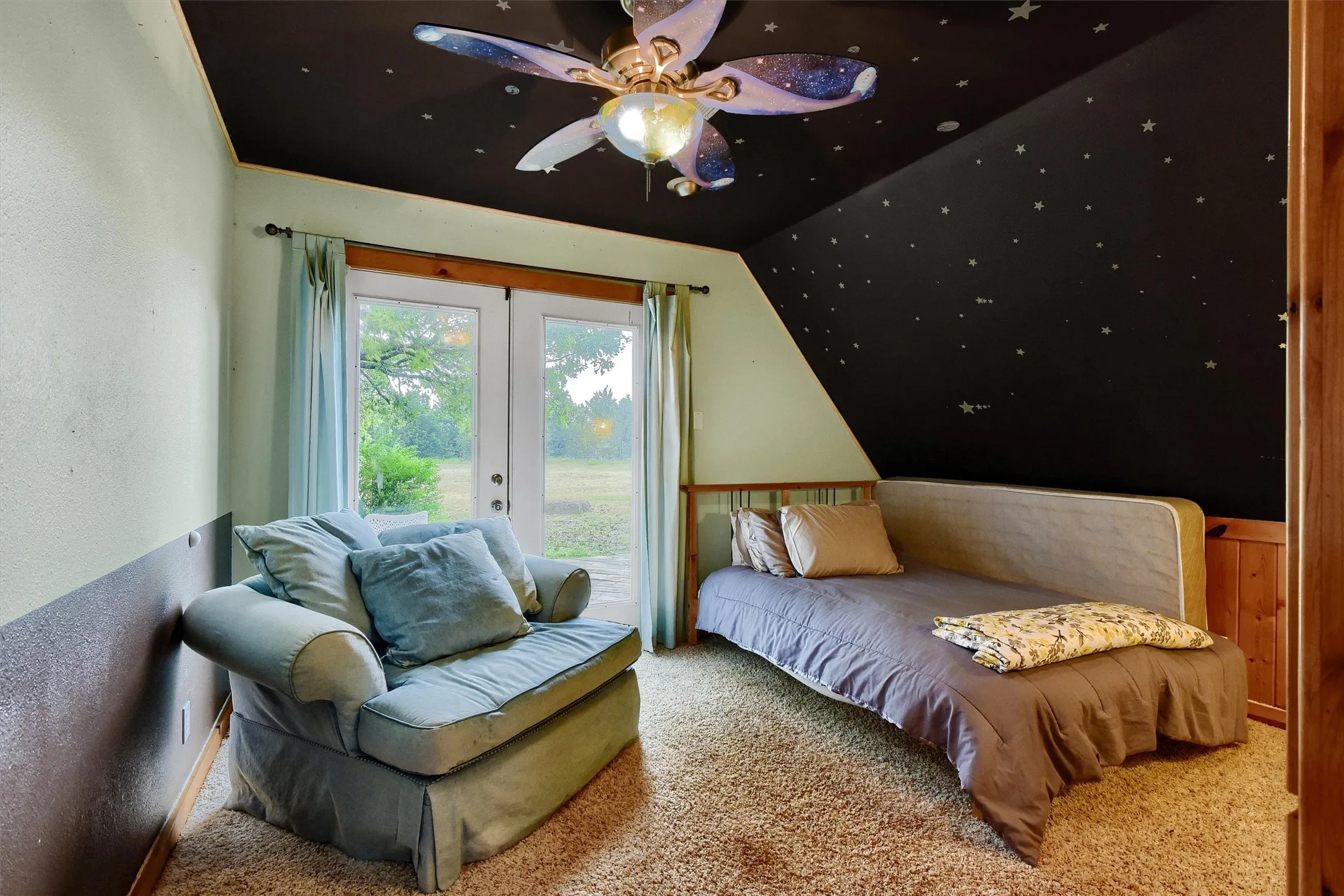 Bedroom featuring ceiling fan, carpet floors, and access to exterior