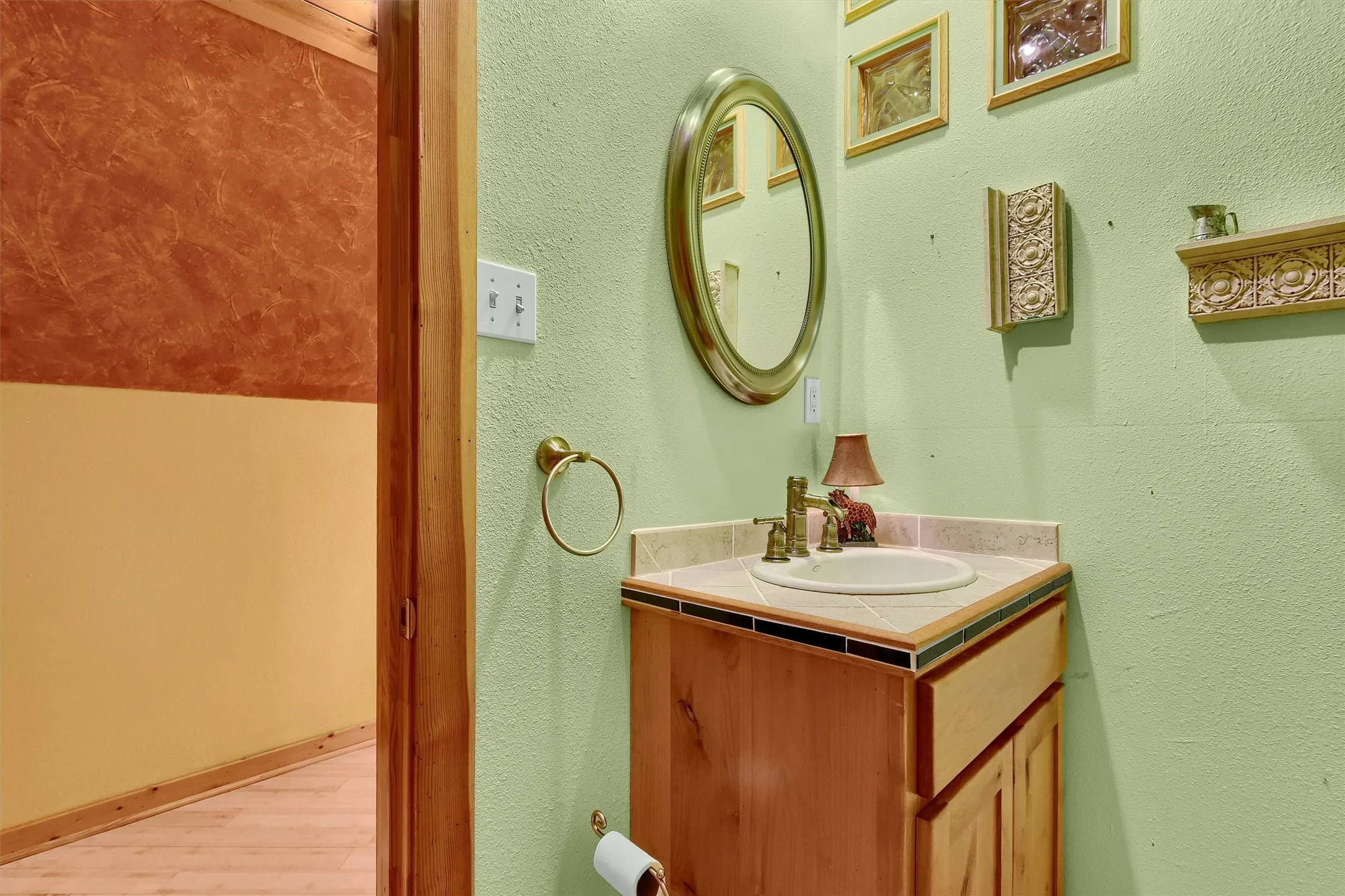 Bathroom featuring hardwood / wood-style flooring and vanity