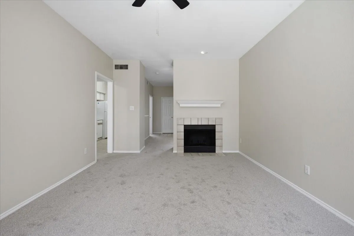 Living room with woodburning fireplace (unstaged)