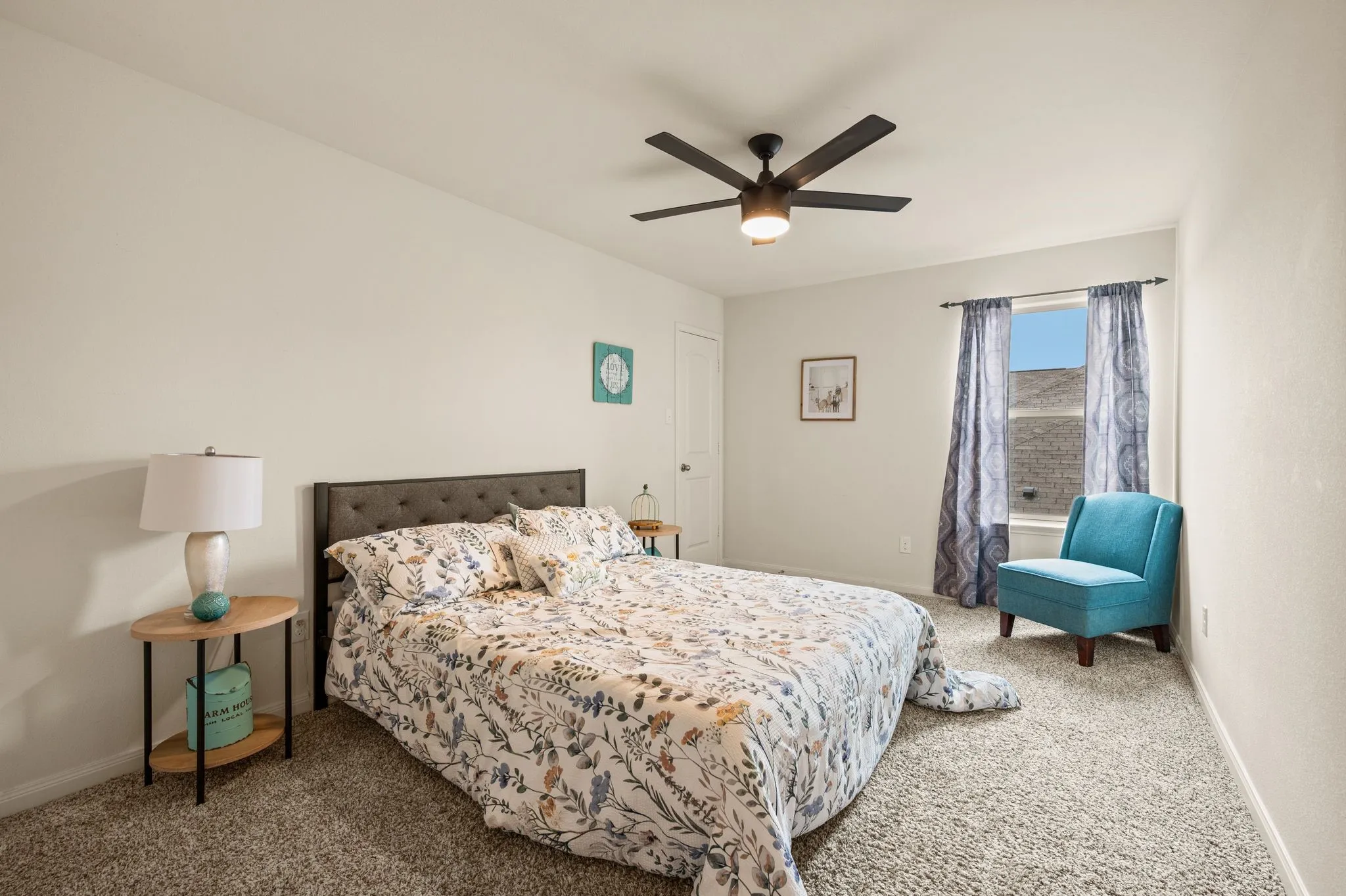 Light-toned wall finishes, built-in ceiling fan with integrated lighting, and soft carpeting