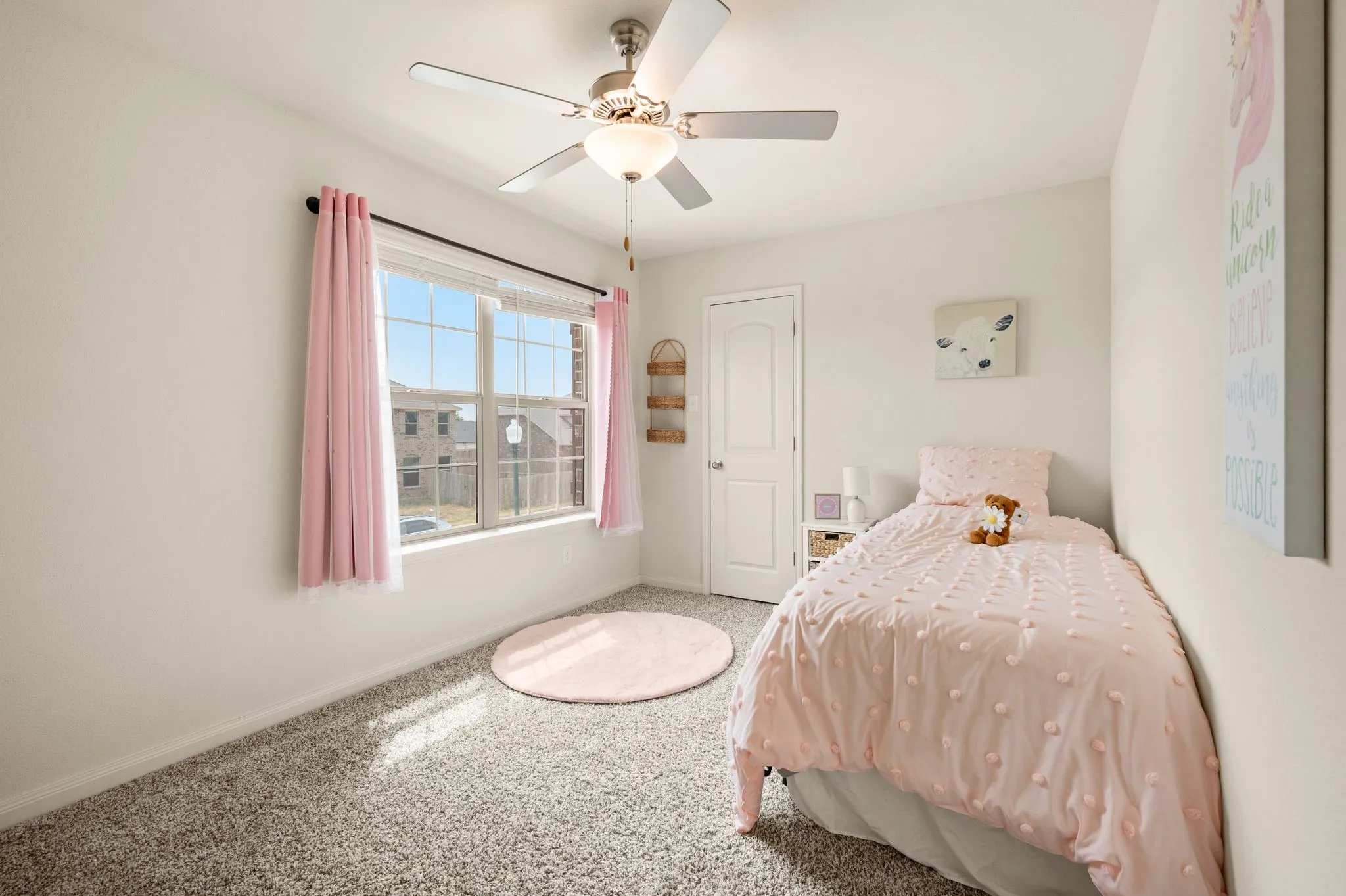Wall-to-wall carpeting with light-colored walls, a ceiling fan with light fixture, and a window