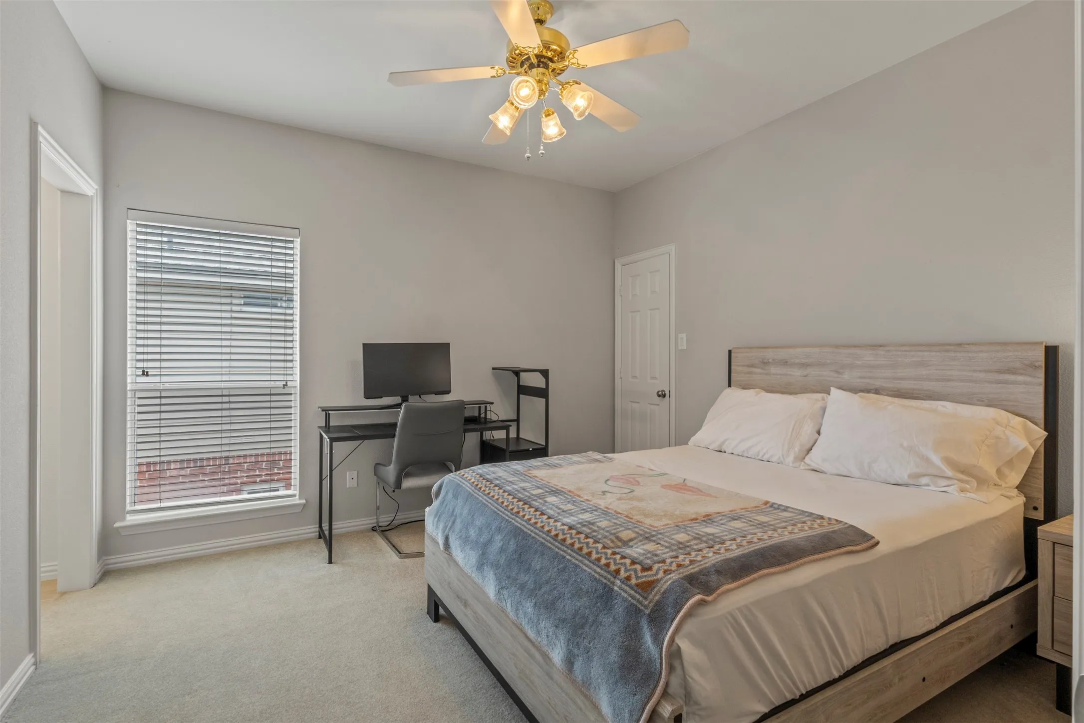 Vaulted ceiling featuring a ceiling fan, window with blinds, and light-colored carpeting