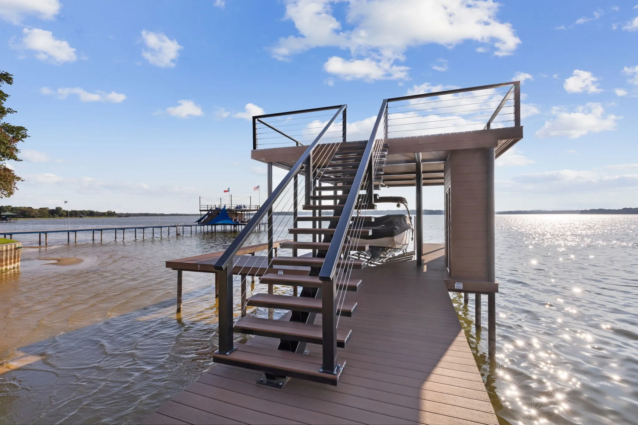 Newer boat dock with 2 boat slips & party deck; positioned when being rebuilt for ease of getting out boat even in dryer seasons.