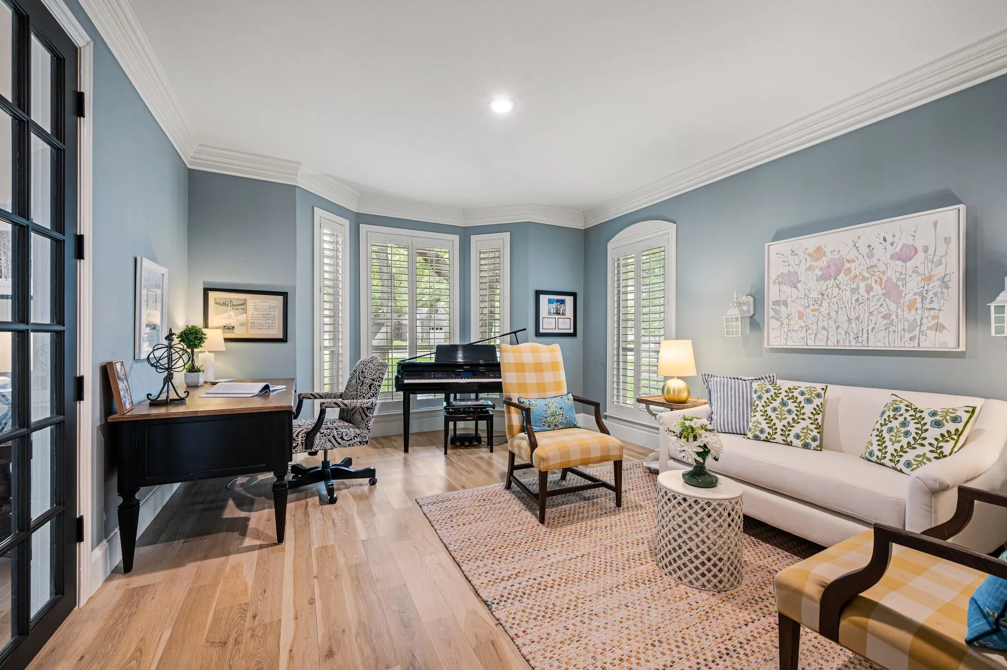 Just off the entry, glass-paned doors open to a light-filled library where built-ins, soft color and garden views create a quiet place to settle in.