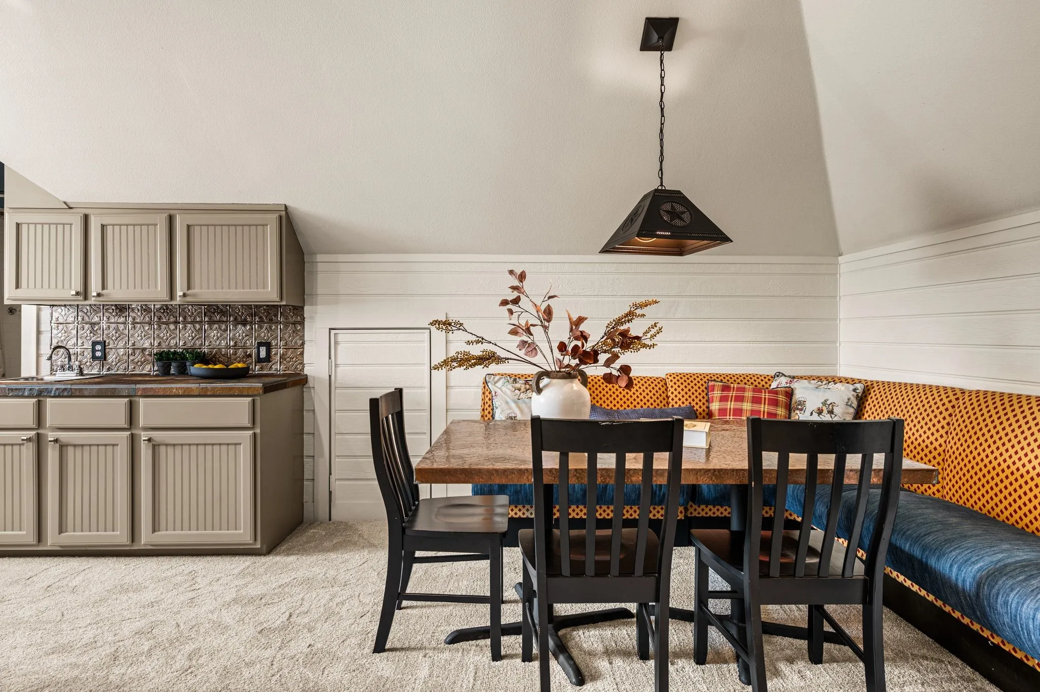 The third-floor game room adds another layer of personality, with a built-in banquette, kitchenette and room for everyone to gather.