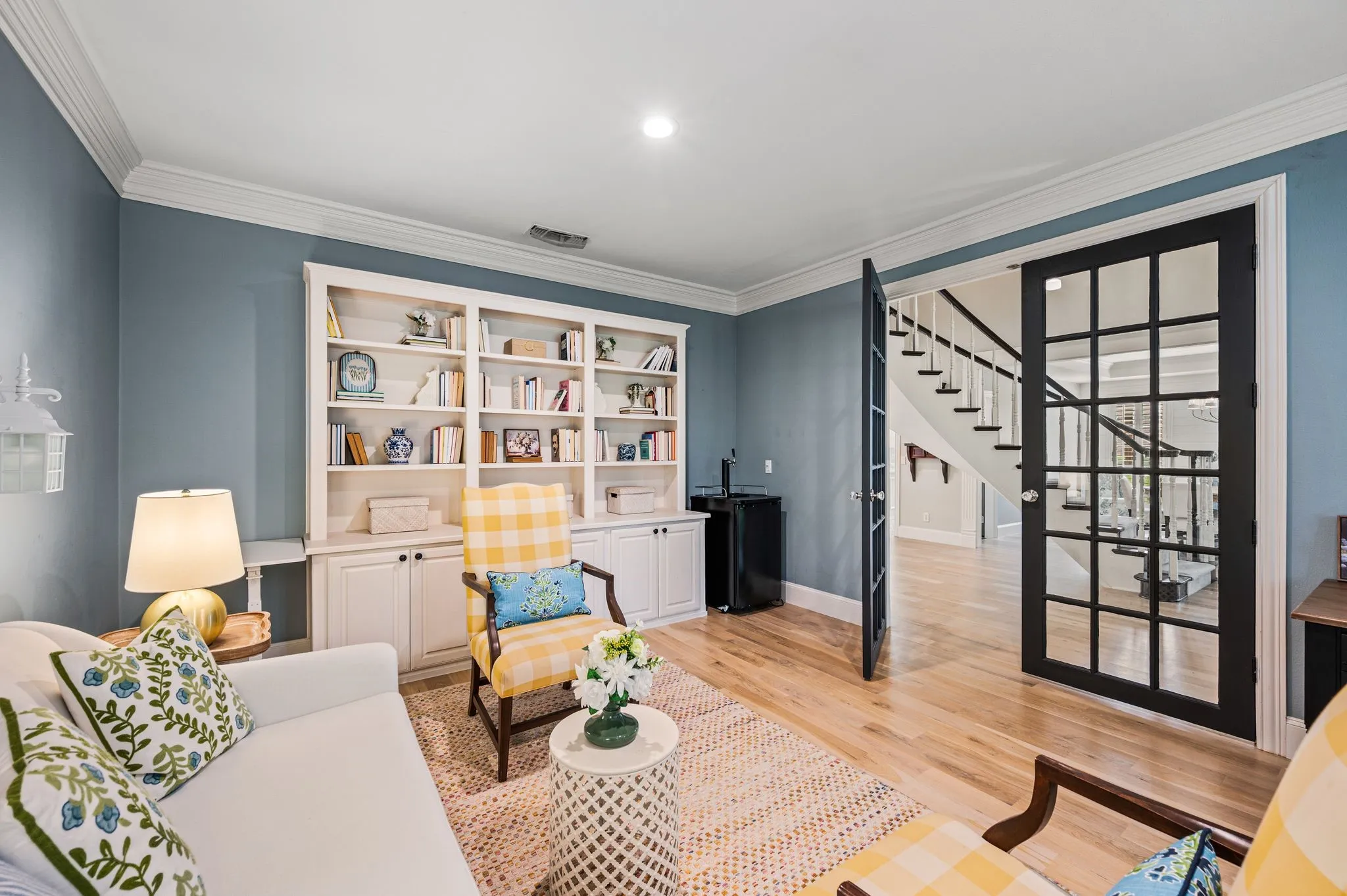 Designed to feel lived in rather than staged, the library layers custom built-ins, wood floors and classic details in a room that feels as comfortable as it is polished.