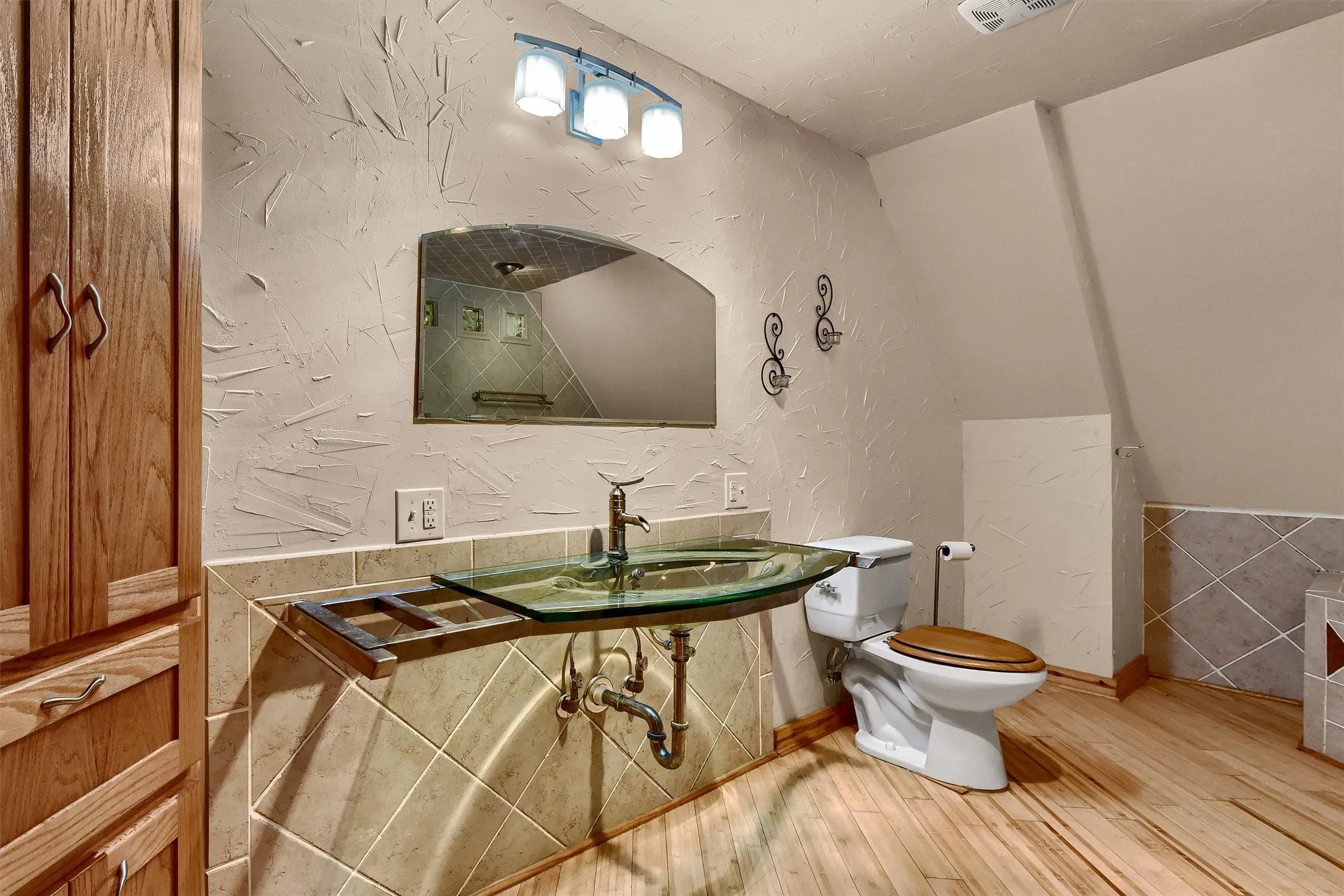 Bathroom with sink, toilet, hardwood / wood-style flooring, and tile walls