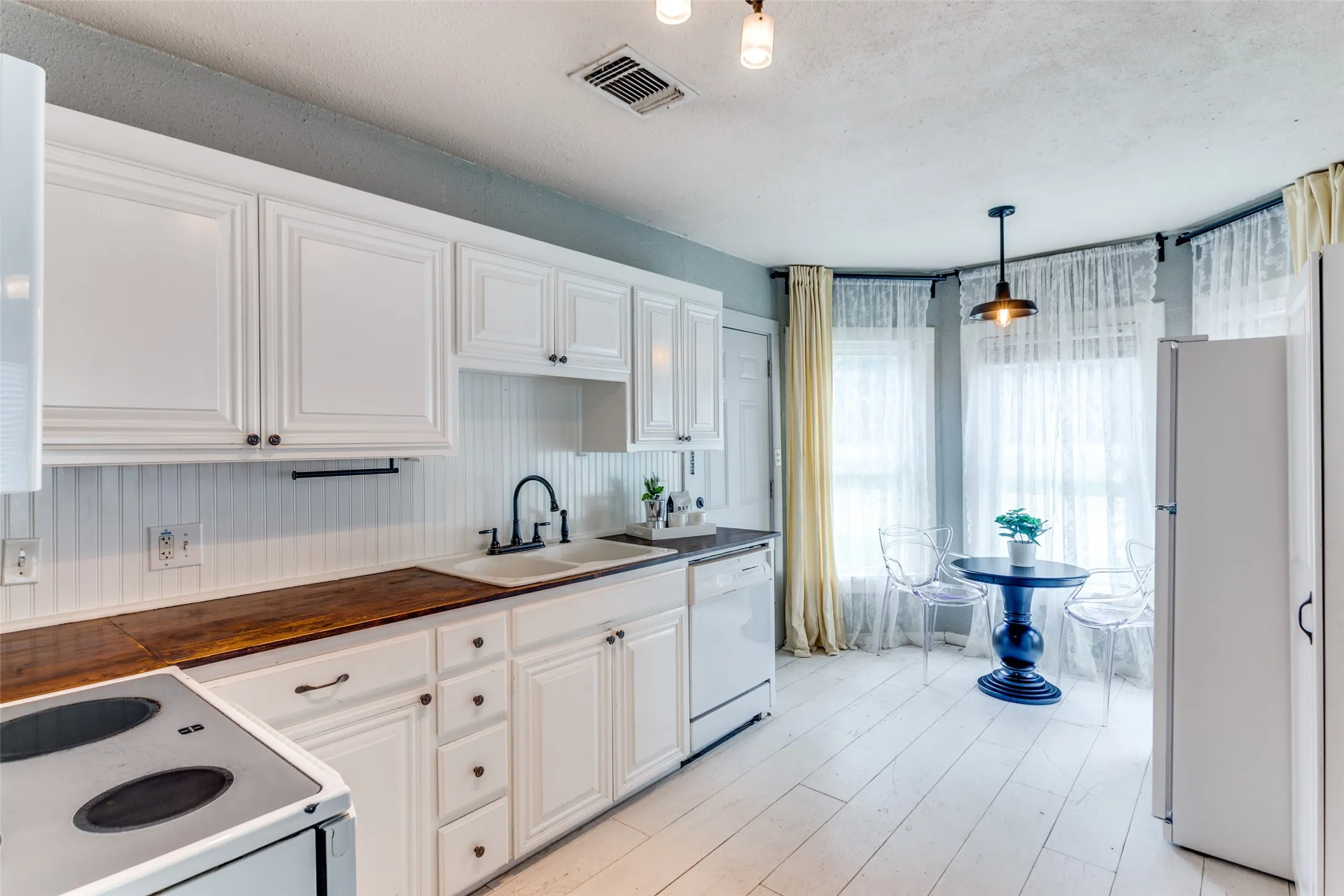 Painted Hardwood Floors In Kitchen Featuring Breakfast Nook